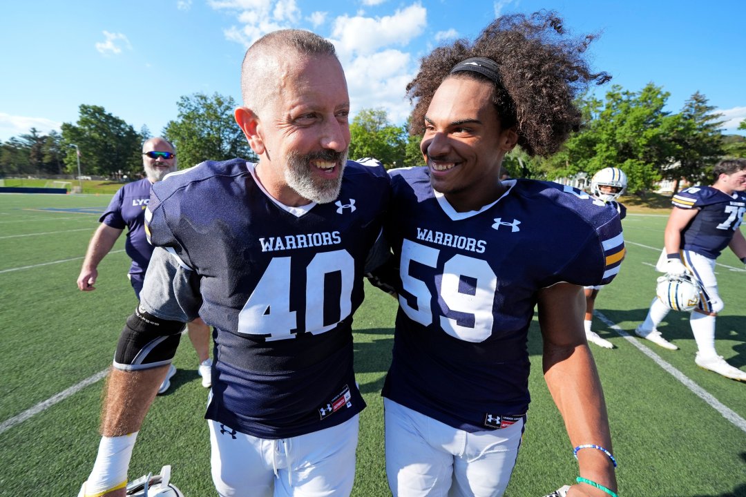 After seeing his first college football game action Lycoming College nose tackle Tom Cillo (40) and Cam Palermo (59) celebrate as they walk to the locker room following a 23-16 win over King's College in an NCAA Division III college football game in Williamsport, Pa., Sunday, Sept. 28, 2025. 