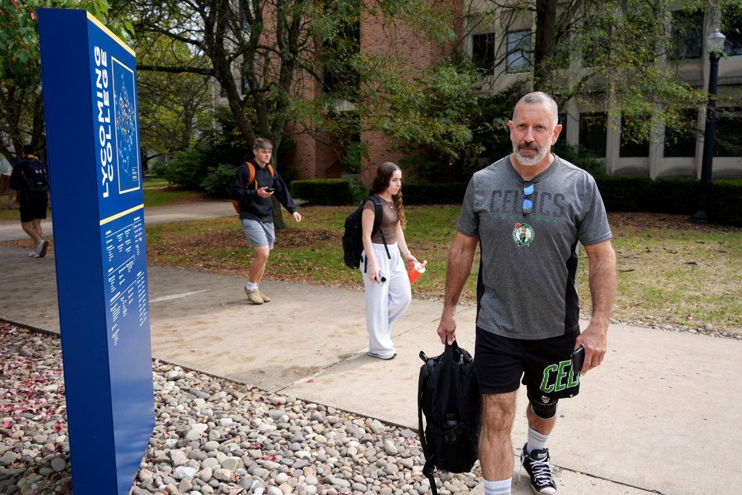 Lycoming College freshman Tom Cillo walks between classes across campus, toting a 40-pound backpack of books, on Monday Sept. 29, 2025 in Williamsport, Pa.