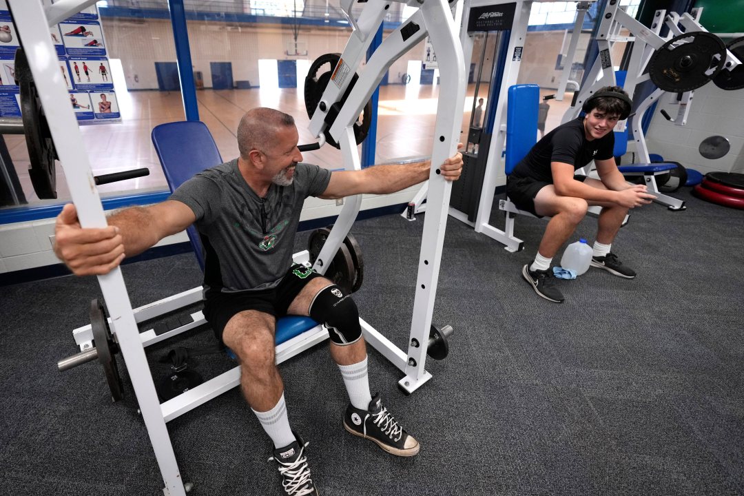 Lycoming College freshman nose tackle Tom Cillo, left, finishes on the incline press machine after attending three classes on Monday Sept. 29, 2025 in Williamsport, Pa.