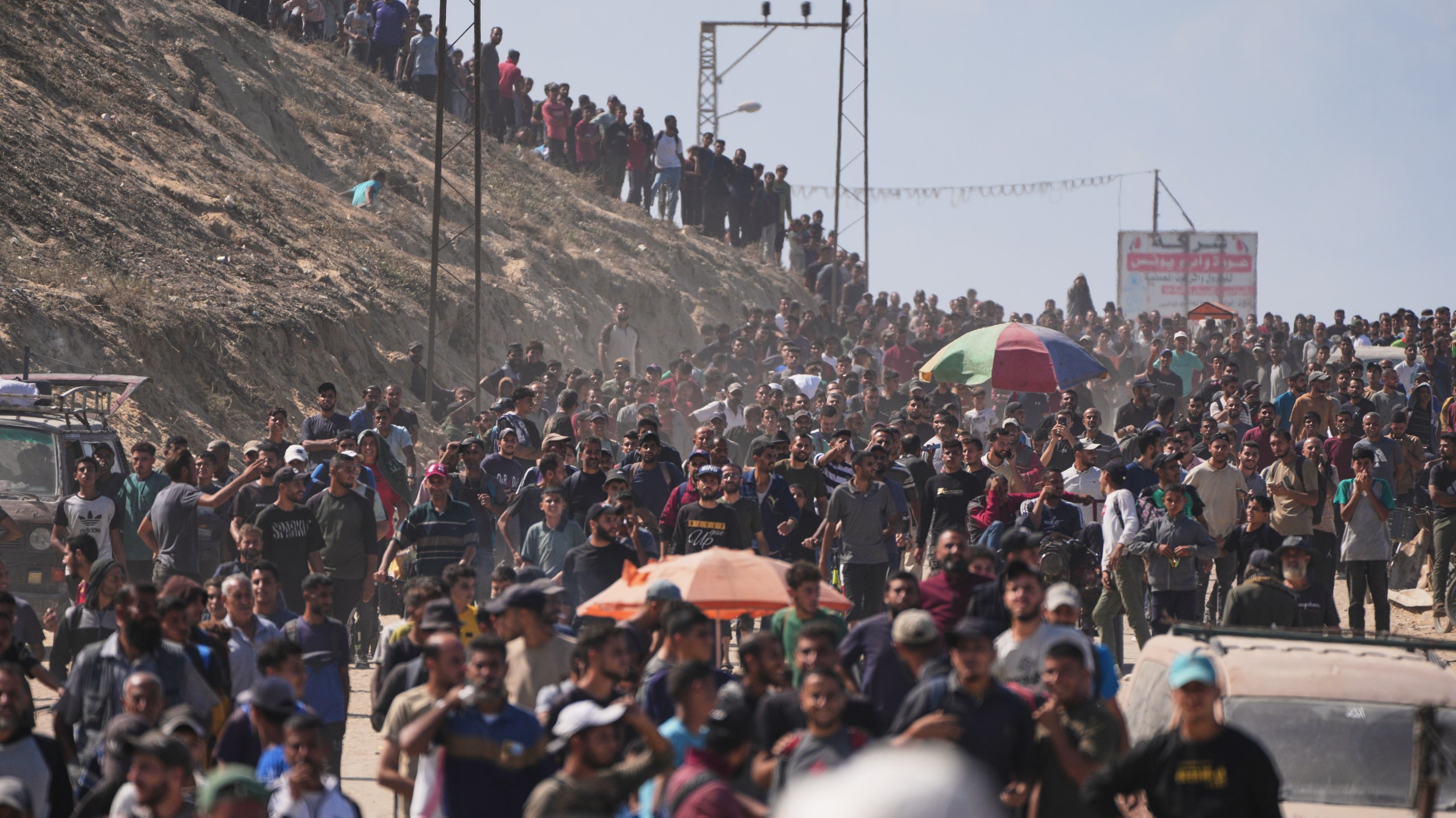 Palestinians walk on a coastal road in Gaza.