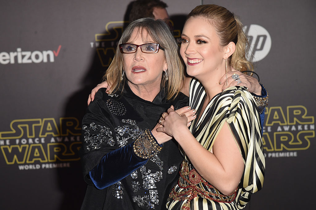 Carrie Fisher and Billie Lourd embrace at an event