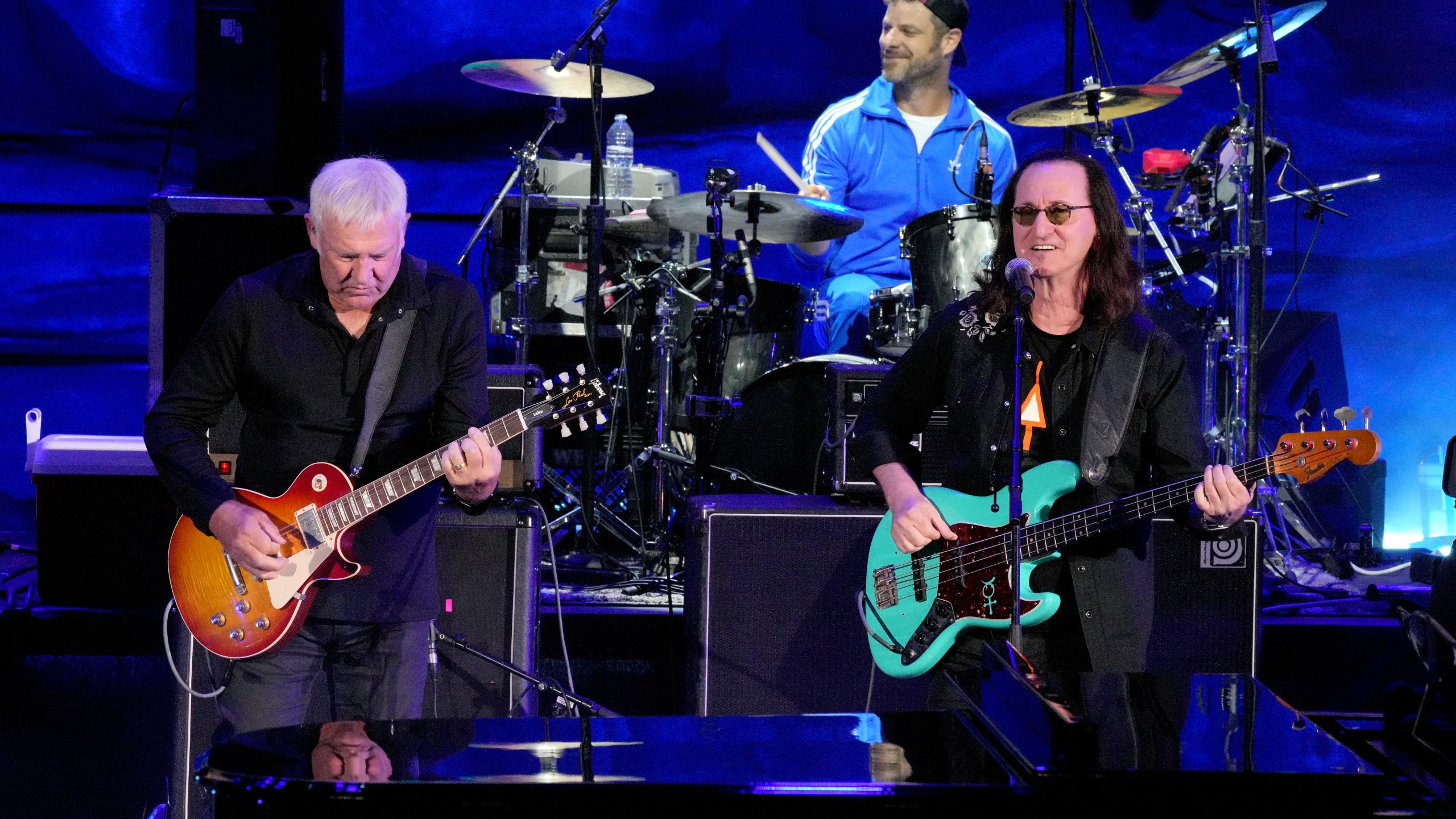 Alex Lifeson and Geddy Lee of the band Rush, and Matt Stone perform on stage
