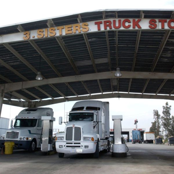 Semi trucks refuel at truck stop, May 18, 2004 in Fontana, California