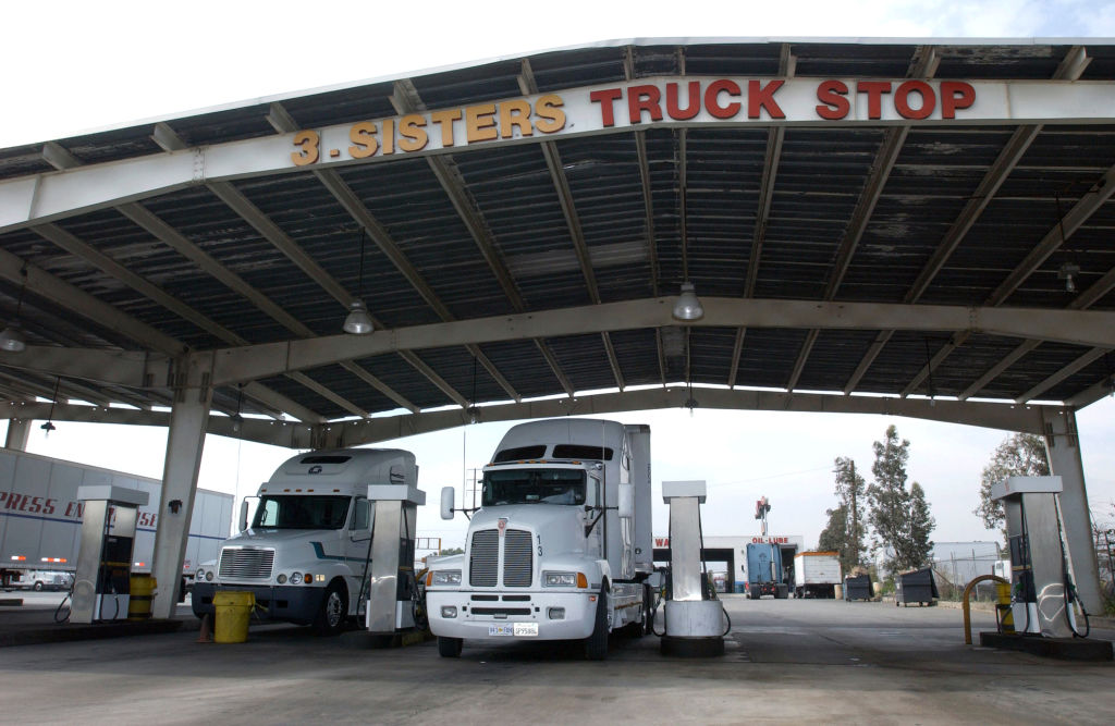 Semi trucks refuel at truck stop, May 18, 2004 in Fontana, California