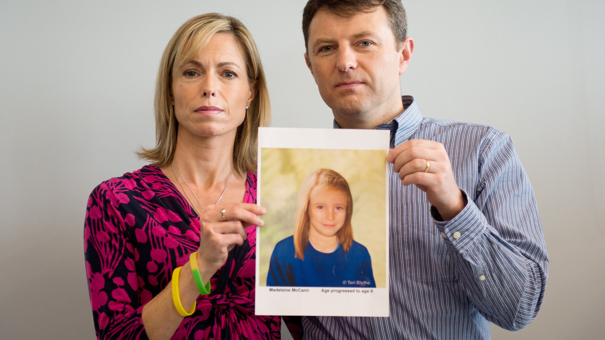 Parents of missing girl Madeleine McCann, Kate (L) and Gerry McCann (R) pose with an artist's impression of how their daughter might look now at the age of nine ahead of a press conference in central London on May 2, 2012 five years after Madeleine's disappearance while on a family holiday in Portugal. 