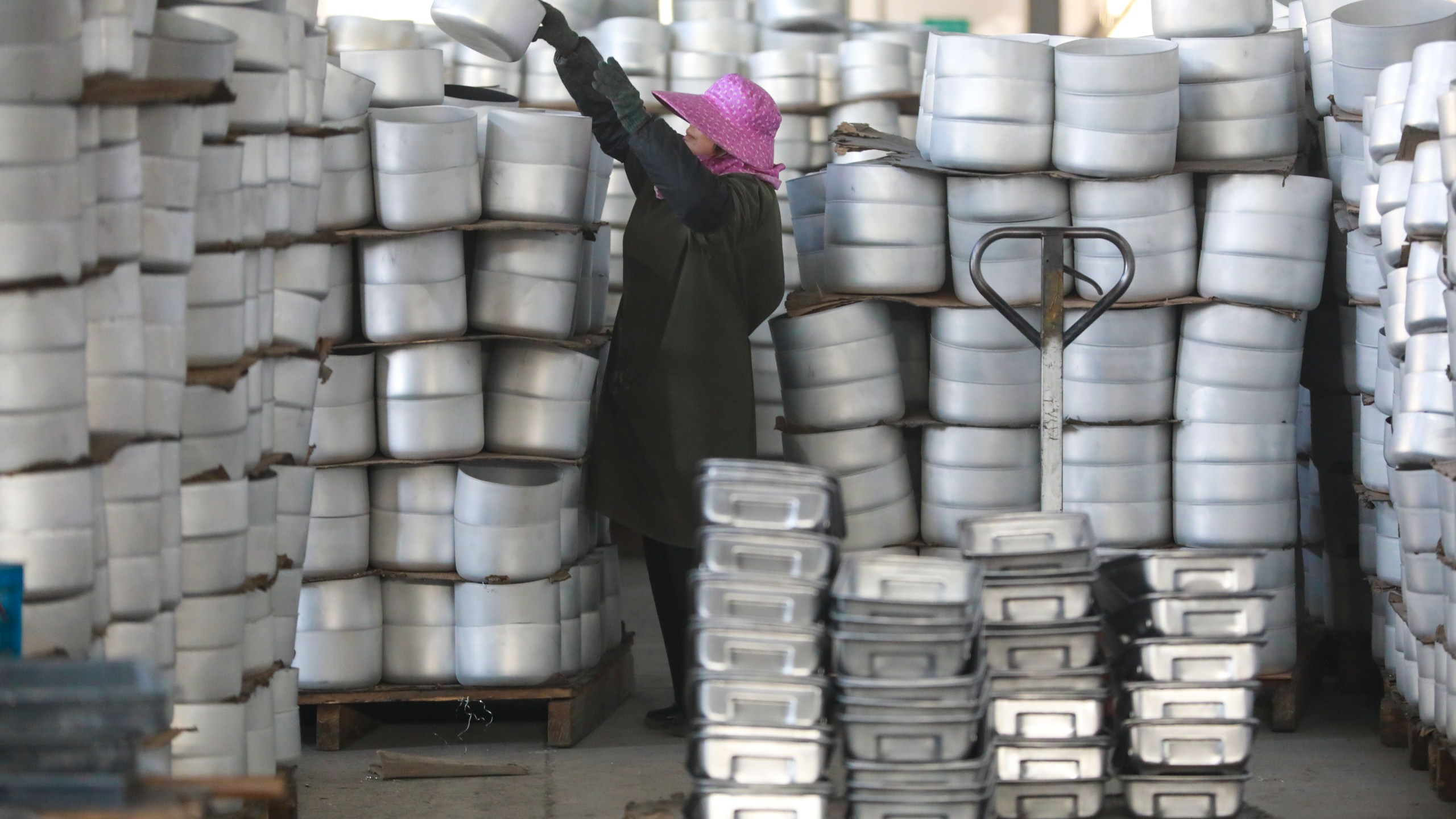 A worker in a workshop making food trays and pans for export in Hangzhou in east China's Zhejiang province Tuesday, Feb. 18, 2025.