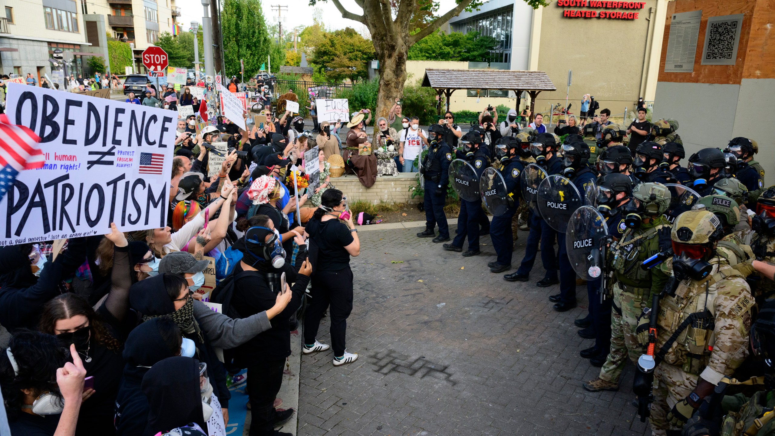 Federal agents confront protesters outside of the U.S. Immigration and Customs Enforcement building on September 28, 202