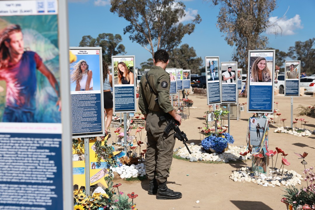 People gather at the former site of the Nova music festival on Oct. 7