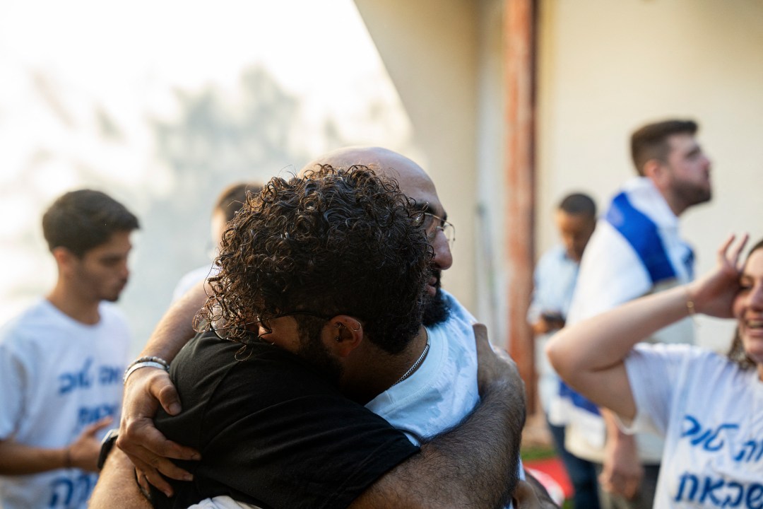 Two family members hug each other at Hostages Square
