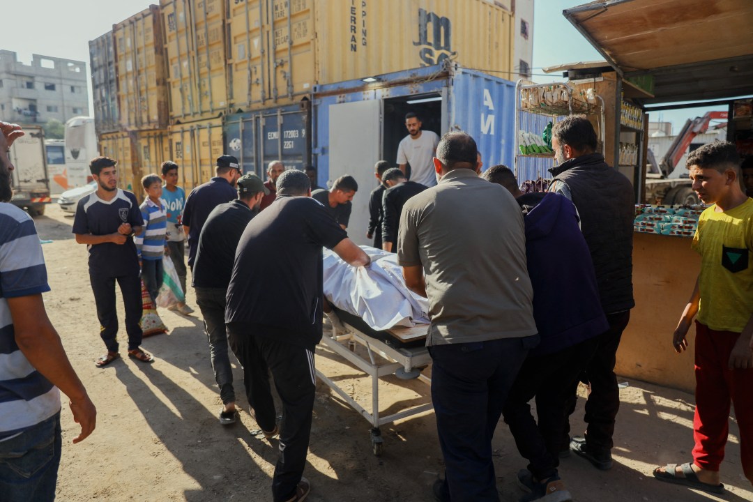 Palestinians push gurney with patient