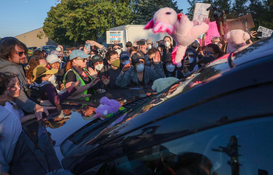 Protesters surround a federal SUV