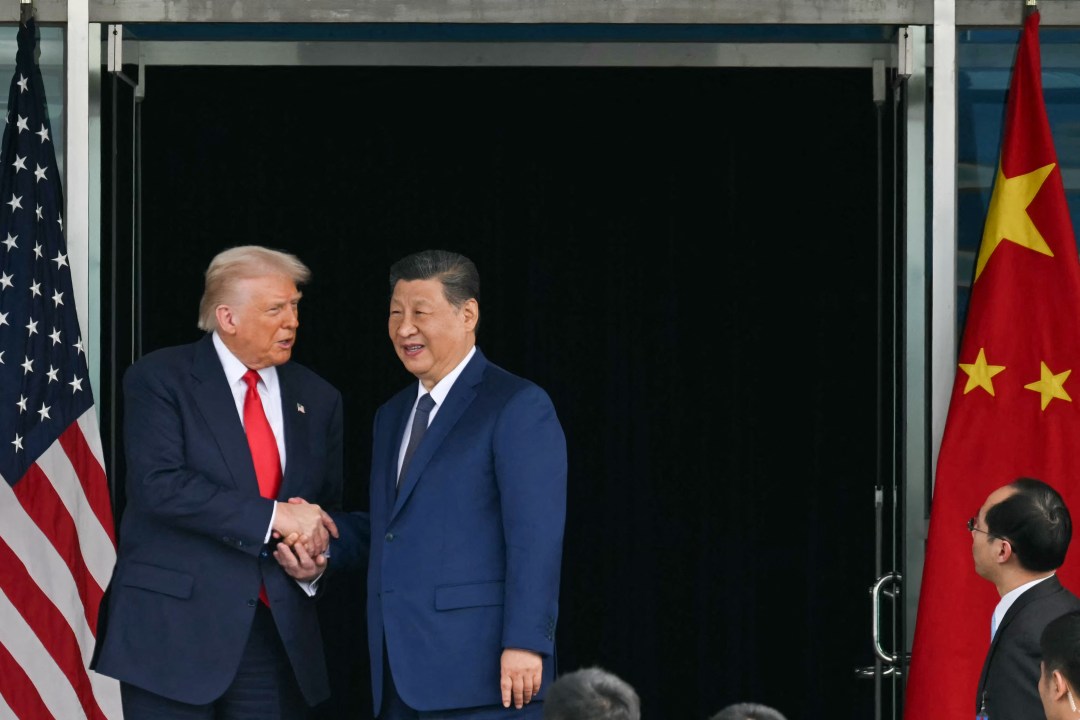 Trump and China's President Xi Jinping shake hand
