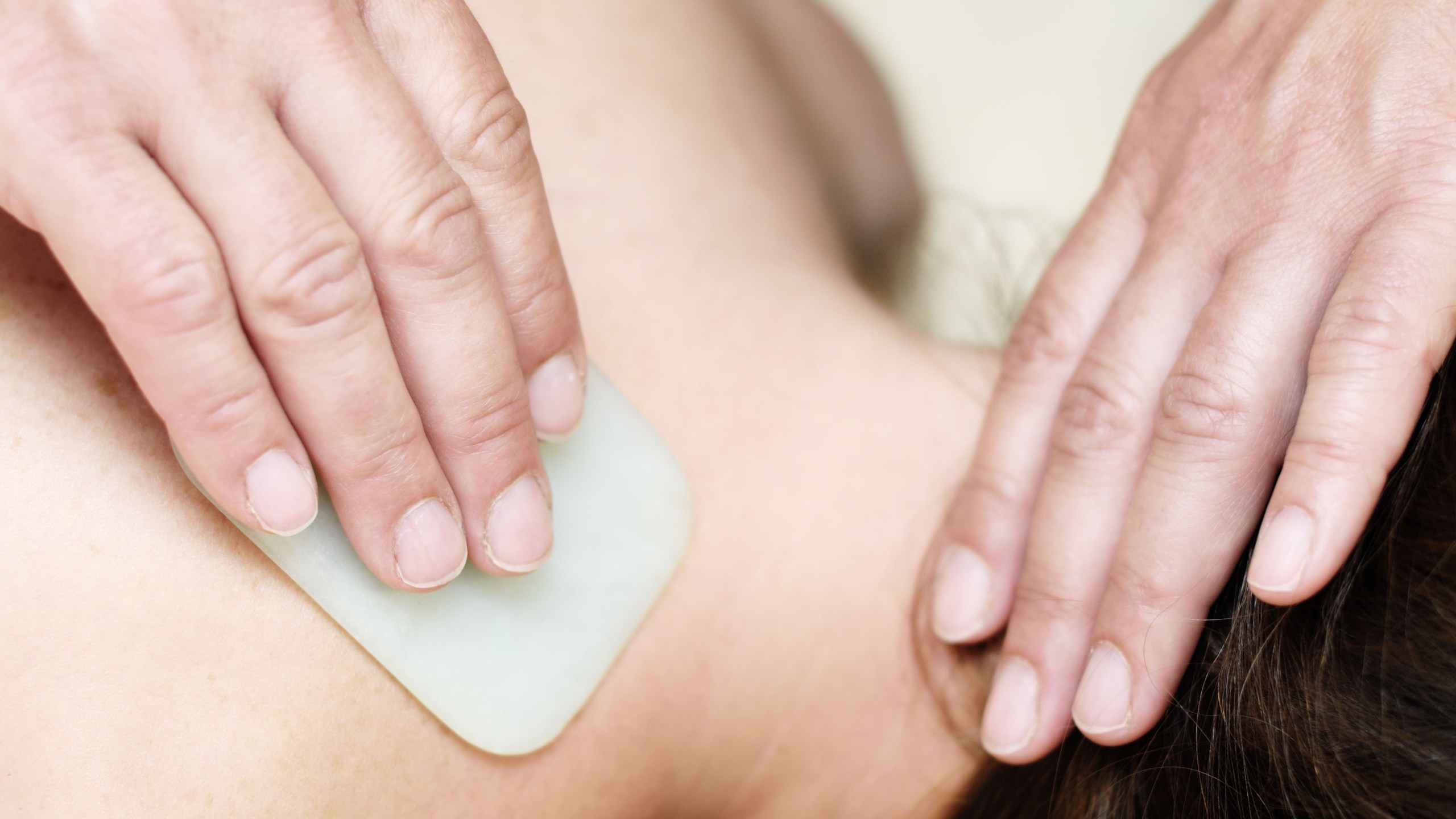 Young woman receiving a Gua Sha treatment in a naturopathic practice (Photo by Christian Ohde/McPhoto/ullstein bild via Getty Images)