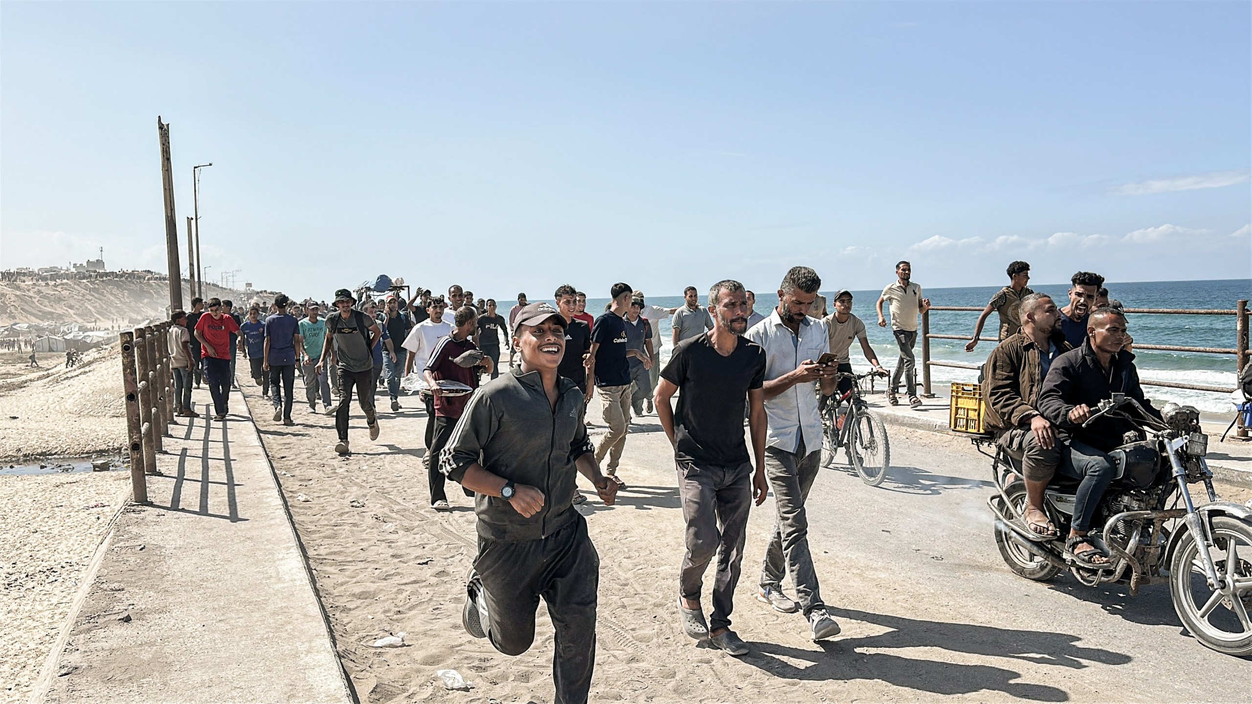 A man runs toward Gaza City