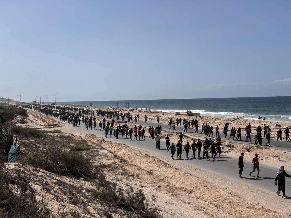 scores of people walking down a road