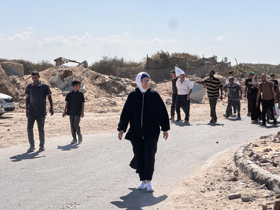 people walk down a road