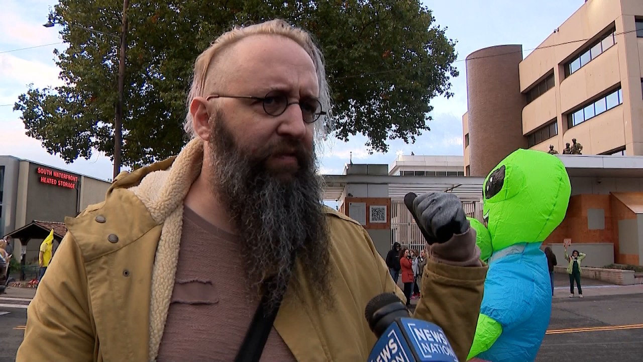 Brooks Brown with alien costume behind him