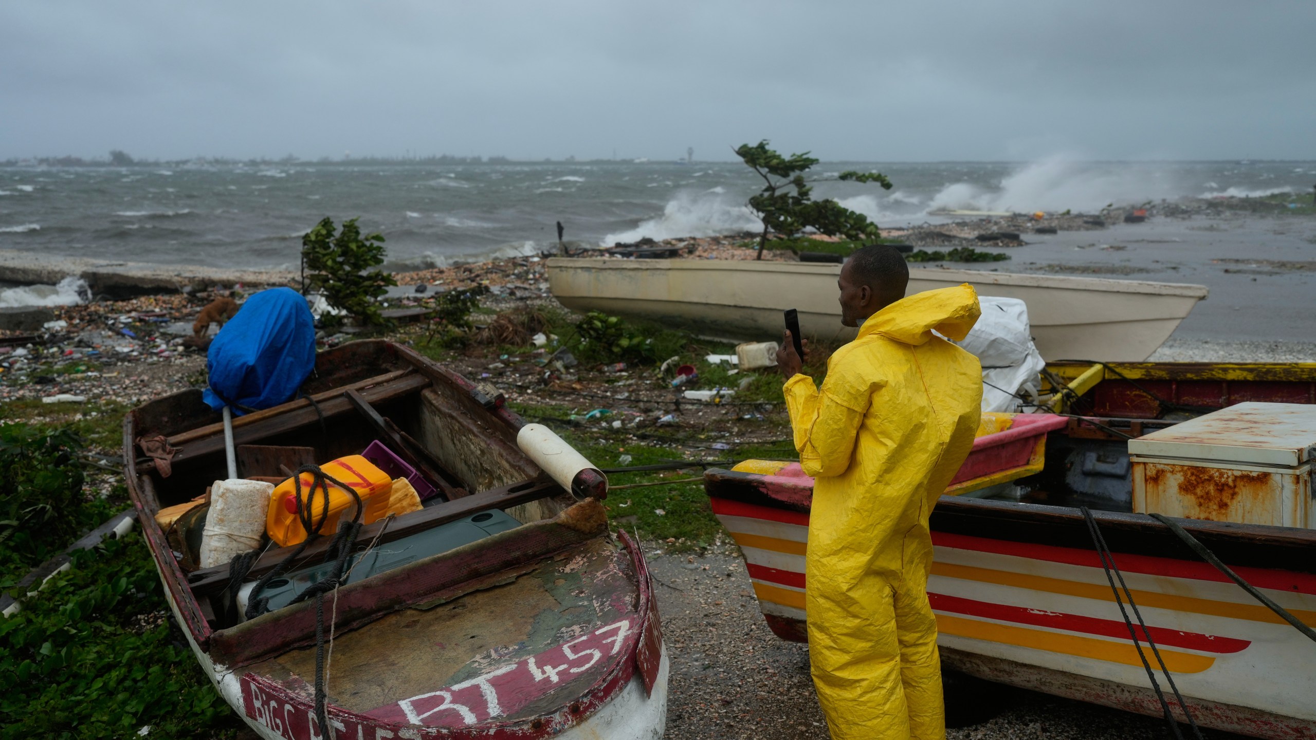 A man watches the coastline in Kingston, Jamaica, as Hurricane Melissa closes in, Tuesday, Oct. 28, 2025. (AP Photo/Matias Delacroix)