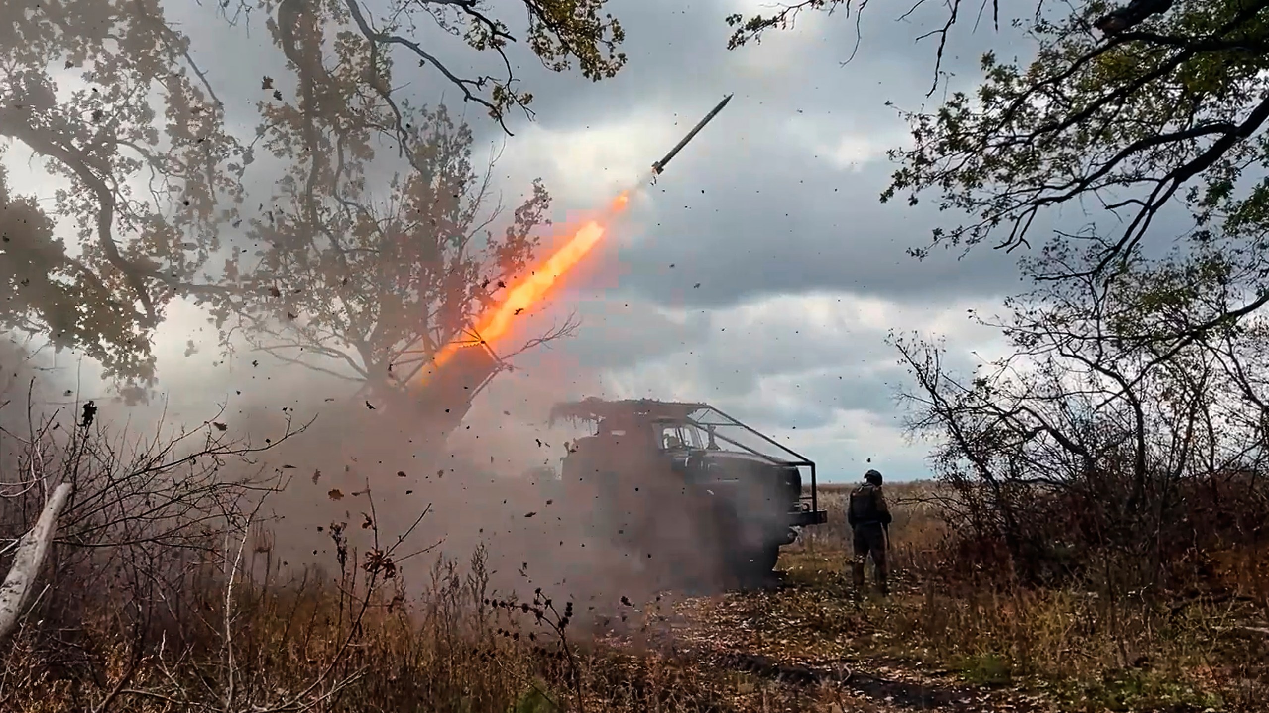 In this image made from video provided by the Russian Defense Ministry Press Service on Friday, Oct. 31, 2025, a Russian "Grad" self-propelled 122 mm multiple rocket launcher fires towards Ukrainian positions on an undisclosed location in Ukraine. (Russian Defense Ministry Press Service via AP)