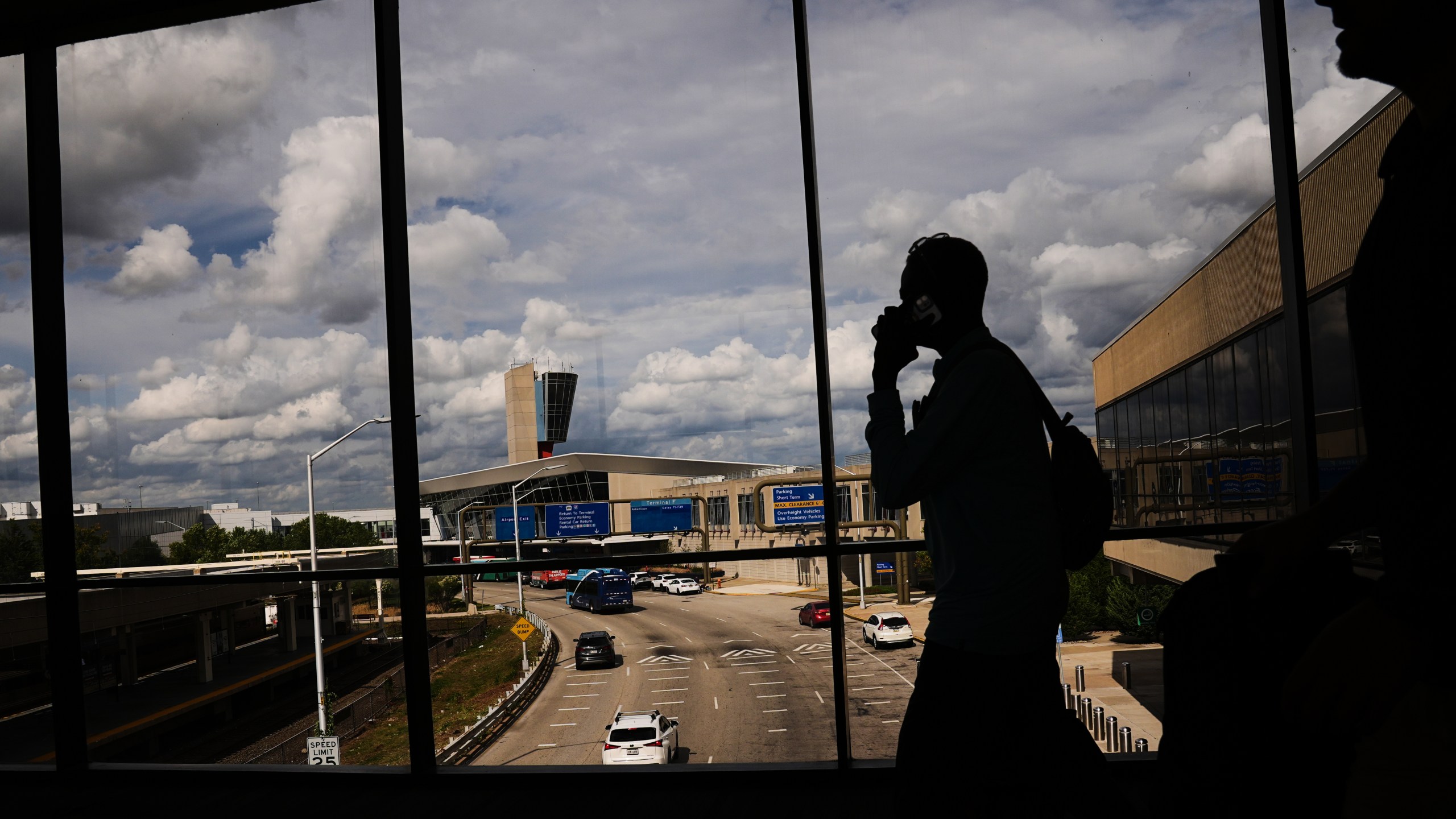 Passengers walk from a terminal at Philadelphia International Airport in Philadelphia, Tuesday, Oct. 7, 2025. (AP Photo/Matt Rourke)