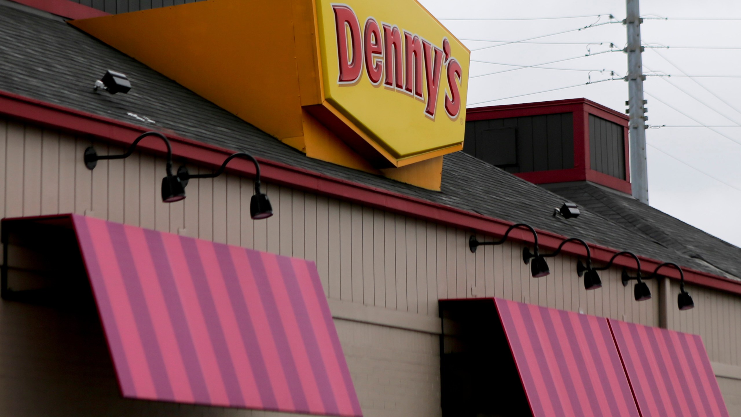 FILE - A large sign marks a Denny's restaurant Sept. 14, 2017, in Cranberry, Pa. (AP Photo/Keith Srakocic, File)