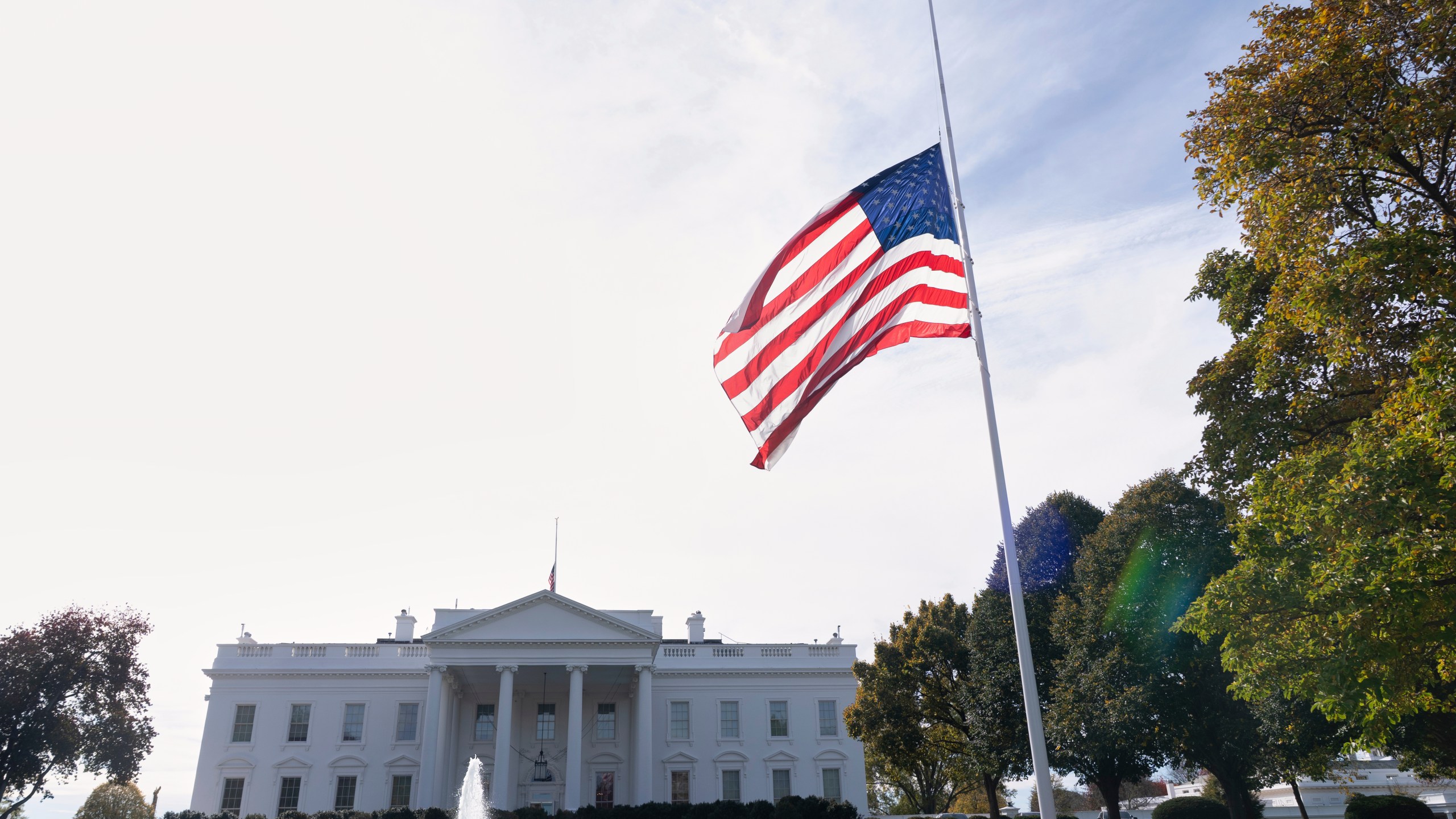The American flag is seen at half-staff, Tuesday, Nov. 4, 2025, at the White House in Washington. (AP Photo/Manuel Balce Ceneta)