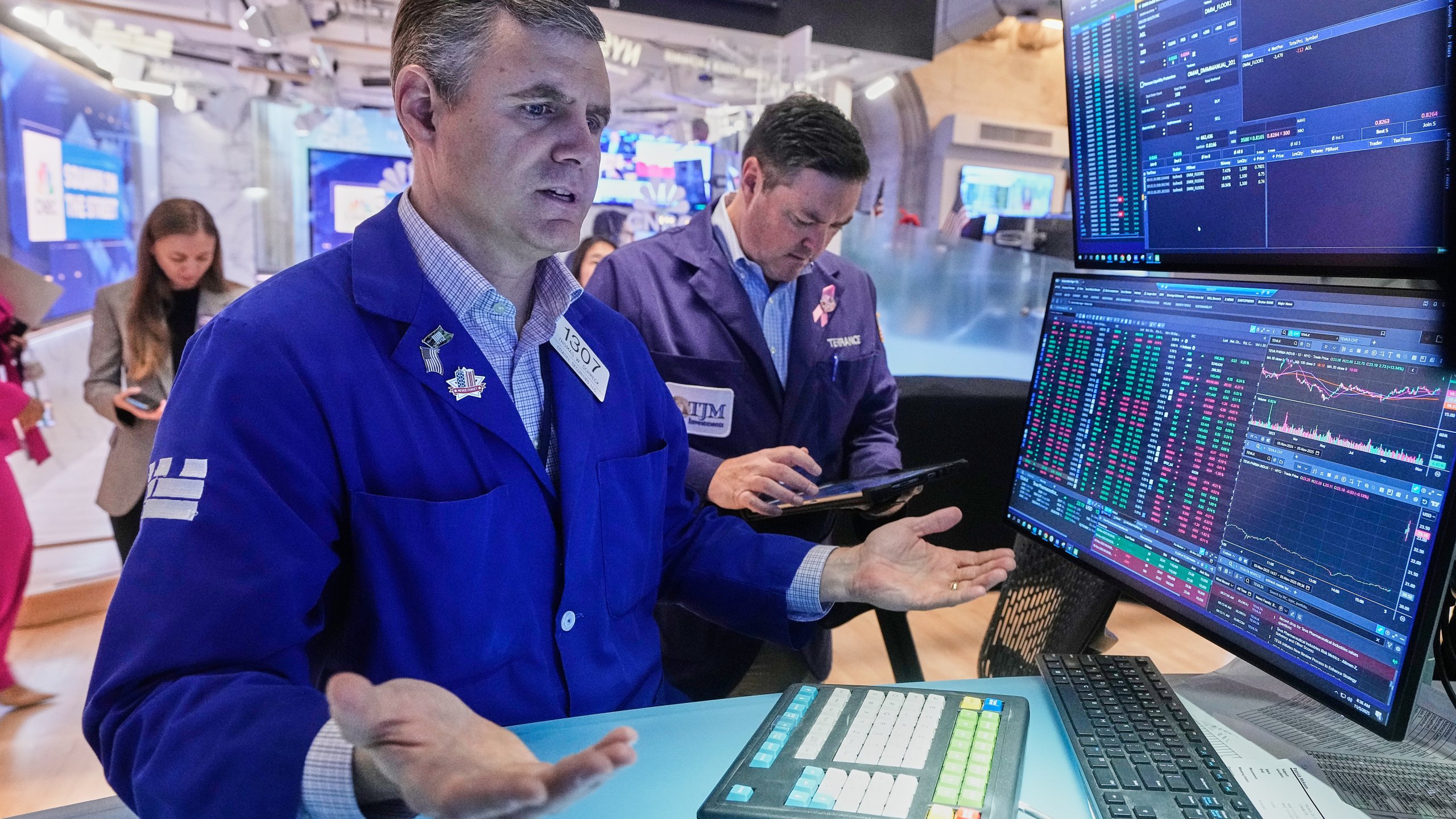 Specialist Thomas Schreck, foreground, works at his post on the floor of the New York Stock Exchange, Wednesday, Nov. 5, 2025. (AP Photo/Richard Drew)