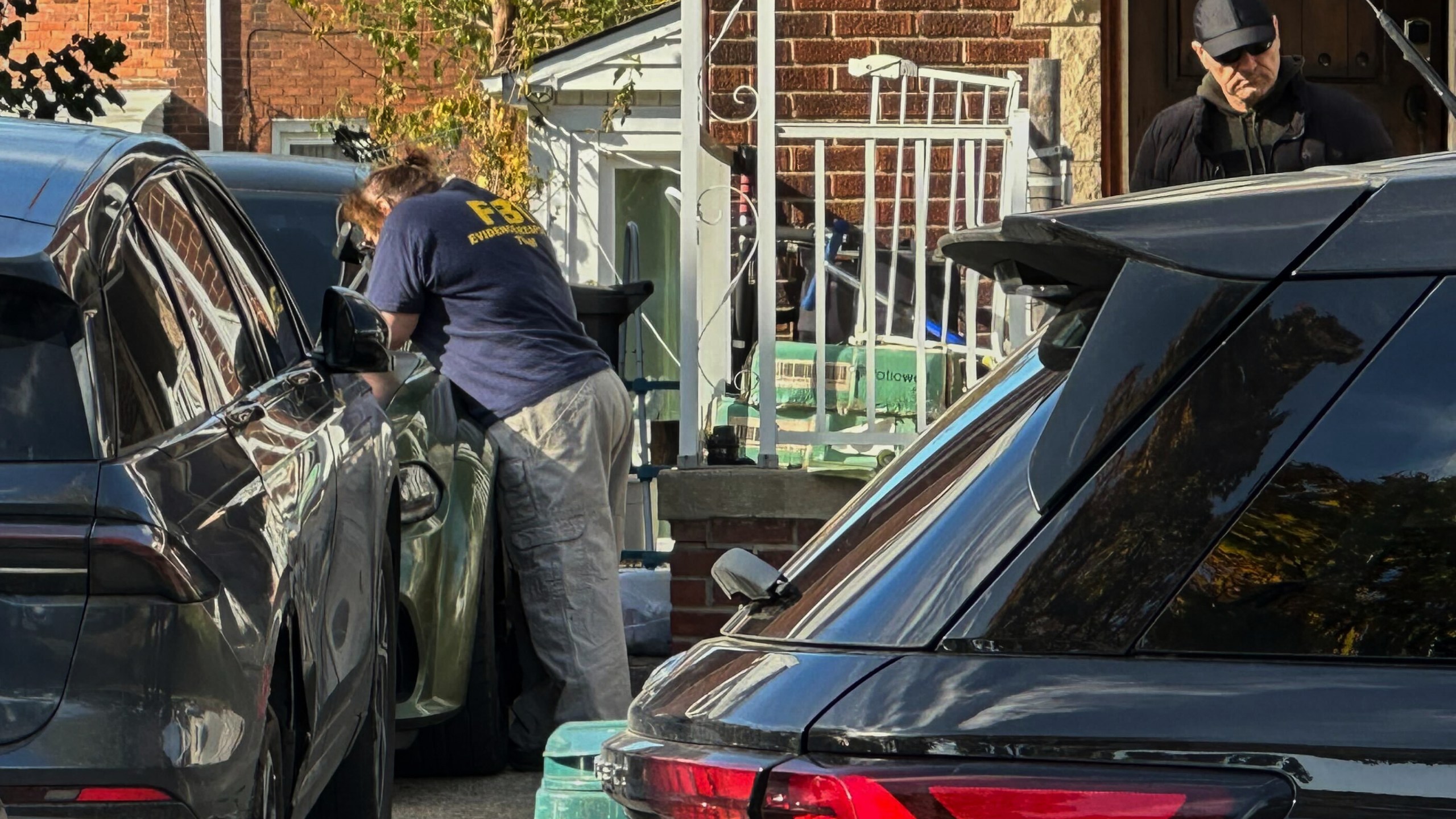 FBI agents gather outside a home in a Dearborn, Mich., neighborhood on Friday, Oct. 31, 2025. (AP Photo/Mike Householder)