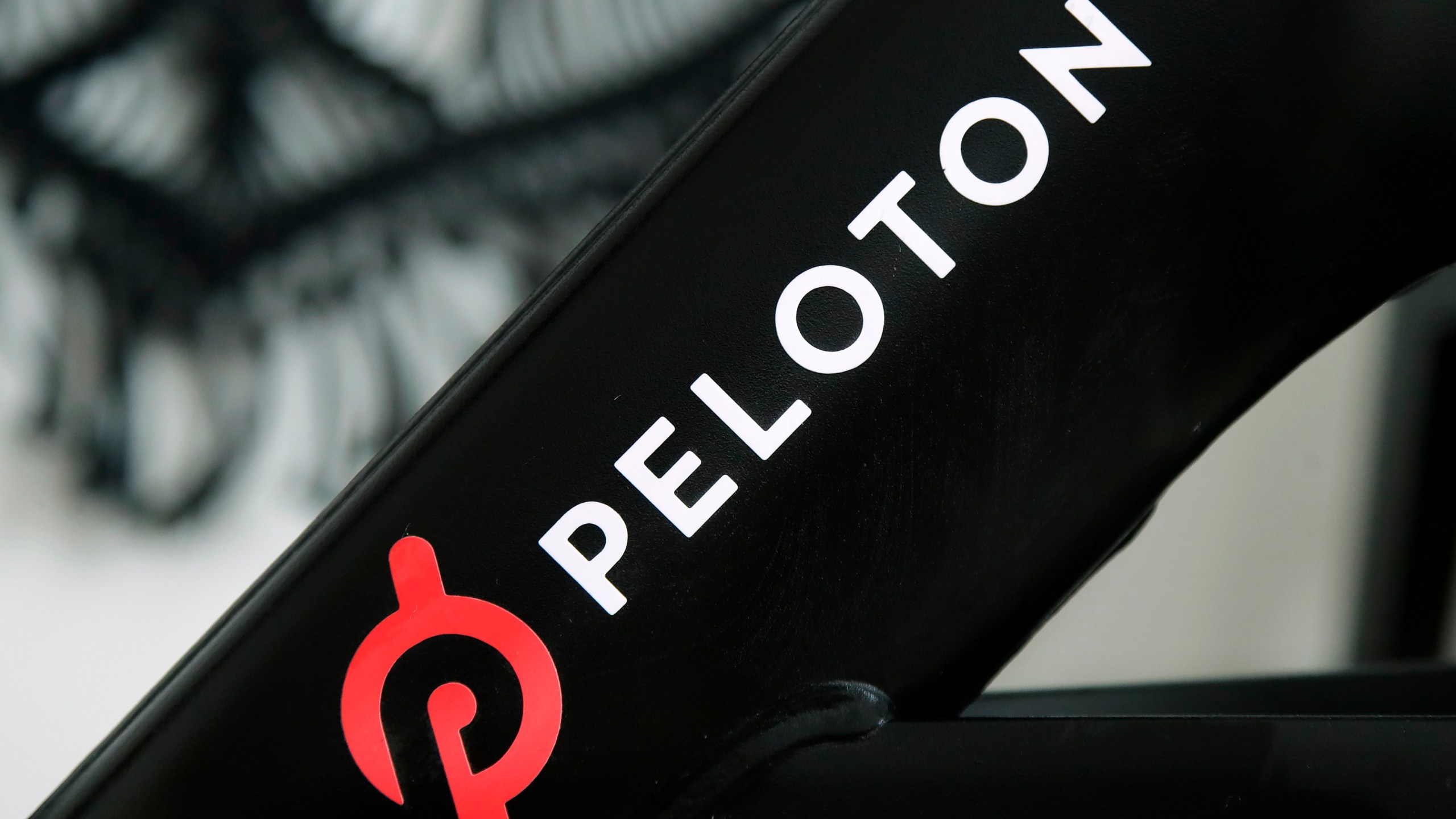 FILE - The Peloton logo is seen on the company's stationary bicycle in San Francisco, Calif., Nov. 19, 2019. (AP Photo/Jeff Chiu, File)