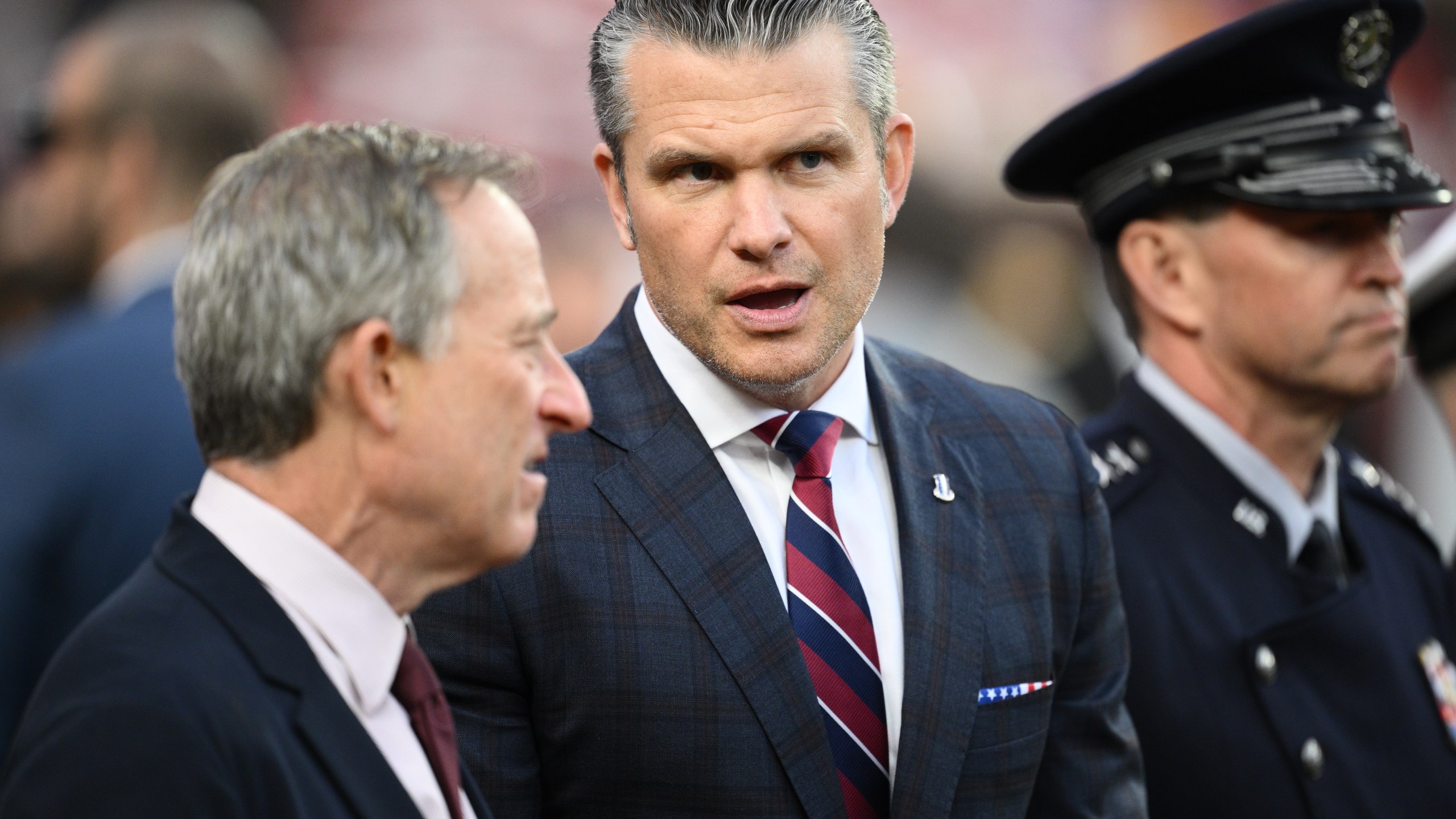 Defense Secretary Pete Hegseth is seen on the sidelines before an NFL football game between the Washington Commanders and the Detroit Lions Sunday, Nov. 9, 2025, in Landover, Md. (AP Photo/Nick Wass)