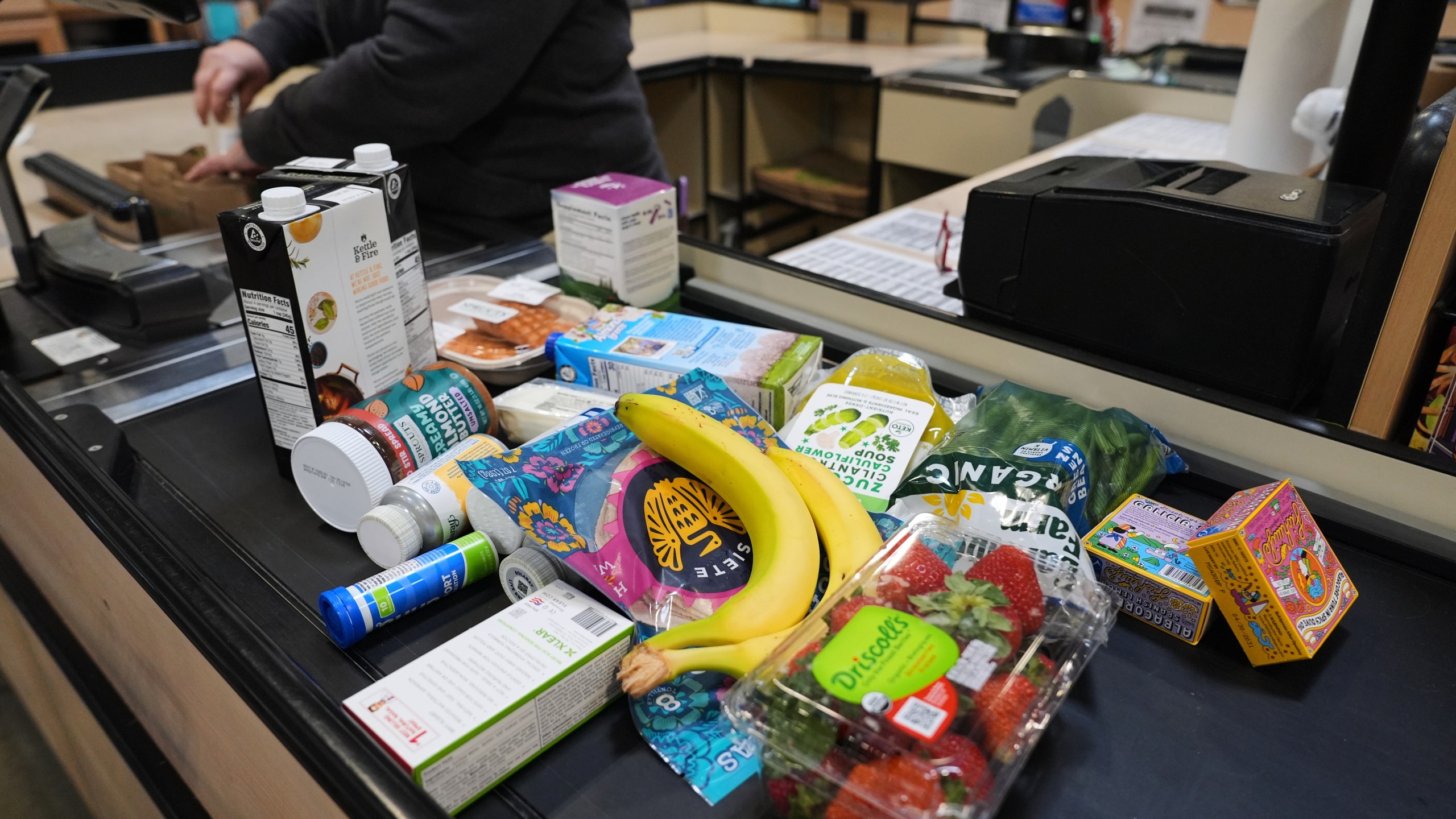 A cashier scans groceries, including produce, which is covered by the USDA Supplemental Nutrition Assistance Program (SNAP), at a grocery store in Baltimore, Monday, Nov. 10, 2025. (AP Photo/Stephanie Scarbrough)