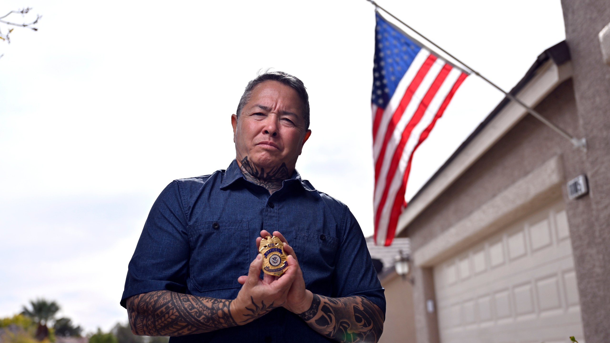 Kai Regan, a former Transportation Security Administration agent, displays his retired TSA badge on Tuesday, Nov. 11, 2025, in Las Vegas. (AP Photo/David Becker)