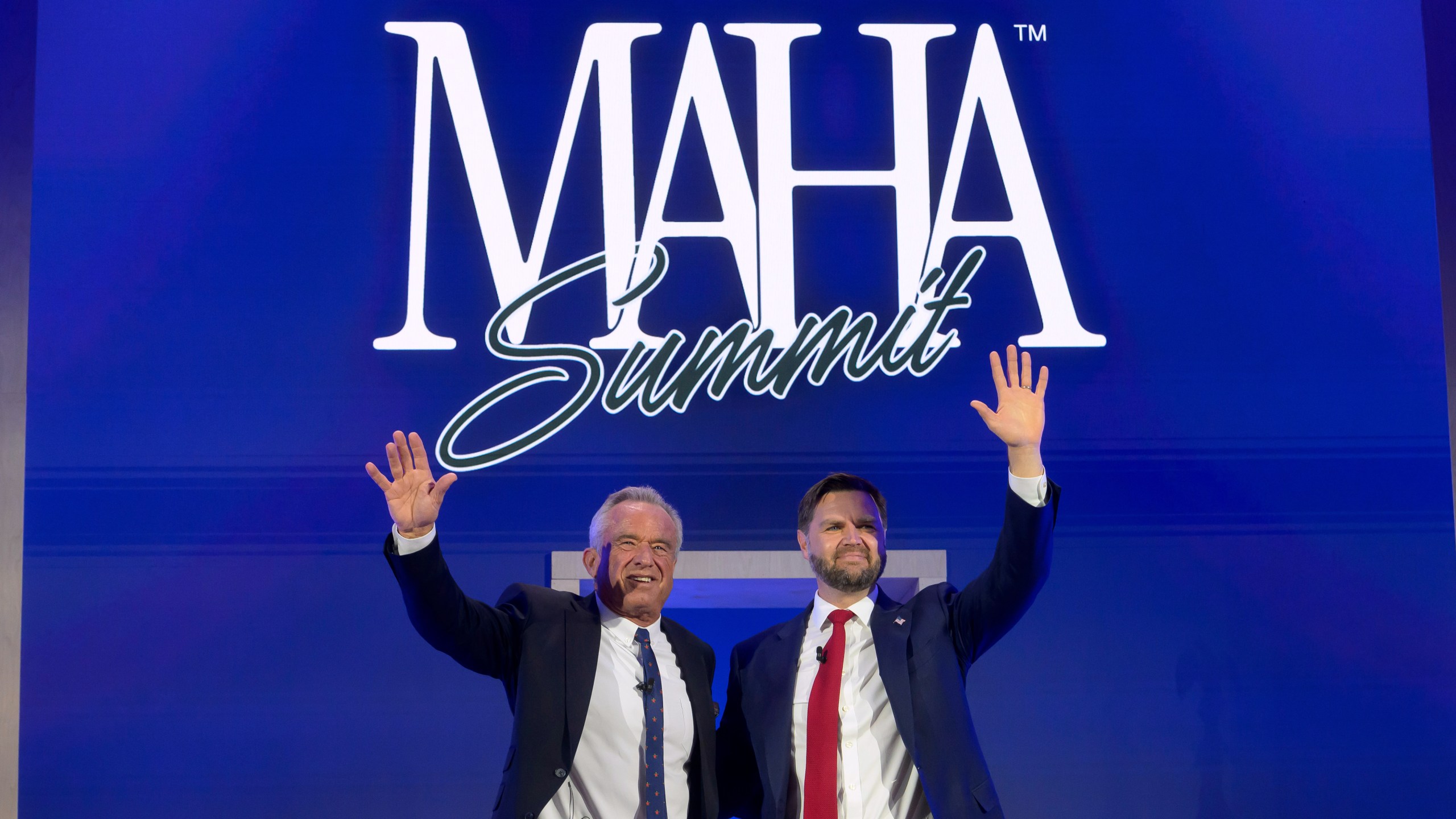 Vice President JD Vance, right, and Health and Human Services Secretary Robert F. Kennedy, Jr., wave as they depart the inaugural Make America Healthy Again summit at the Waldorf Astoria, Wednesday, Nov. 12, 2025, in Washington. (AP Photo/Rod Lamkey, Jr.)