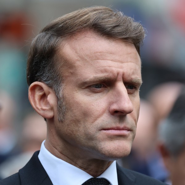 French President Emmanuel Macron pays his respects to victims near Le Bonne Biere cafe, Thursday Nov. 13, 2025 in Paris during ceremonies marking the 10th anniversary of terrorist attacks that killed 132 people and injured hundreds. (Ludovic Marin, Pool photo via AP)