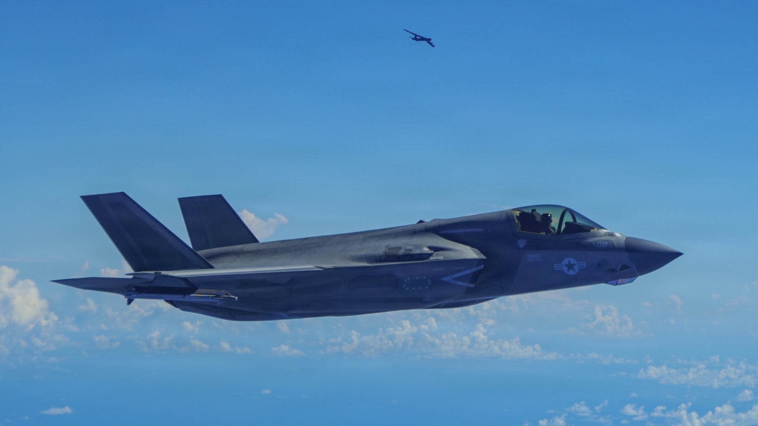 In this image provided by the U.S. Air Force, a Marine Corps F-35B Lightning II aircraft flies alongside a U.S. Air Force B-52H Stratofortress bomber in the U.S. Southern Command area of responsibility, Oct. 15, 2025. (U.S. Air Force via AP)
