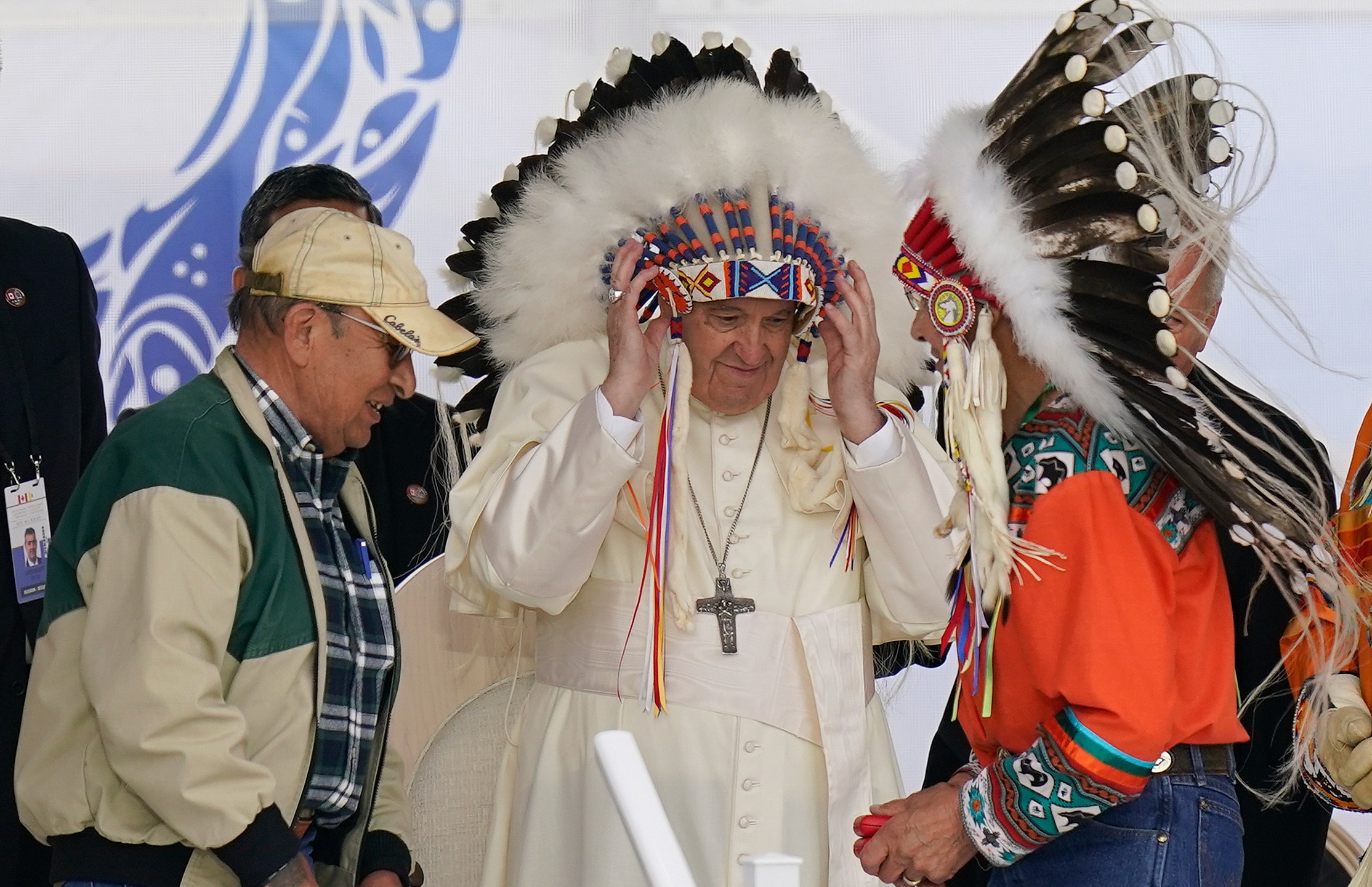 FILE - Pope Francis dons a headdress during a visit with Indigenous peoples at Maskwaci, the former Ermineskin Residential School, Monday, July 25, 2022, in Maskwacis, Alberta. (AP Photo/Eric Gay, File)