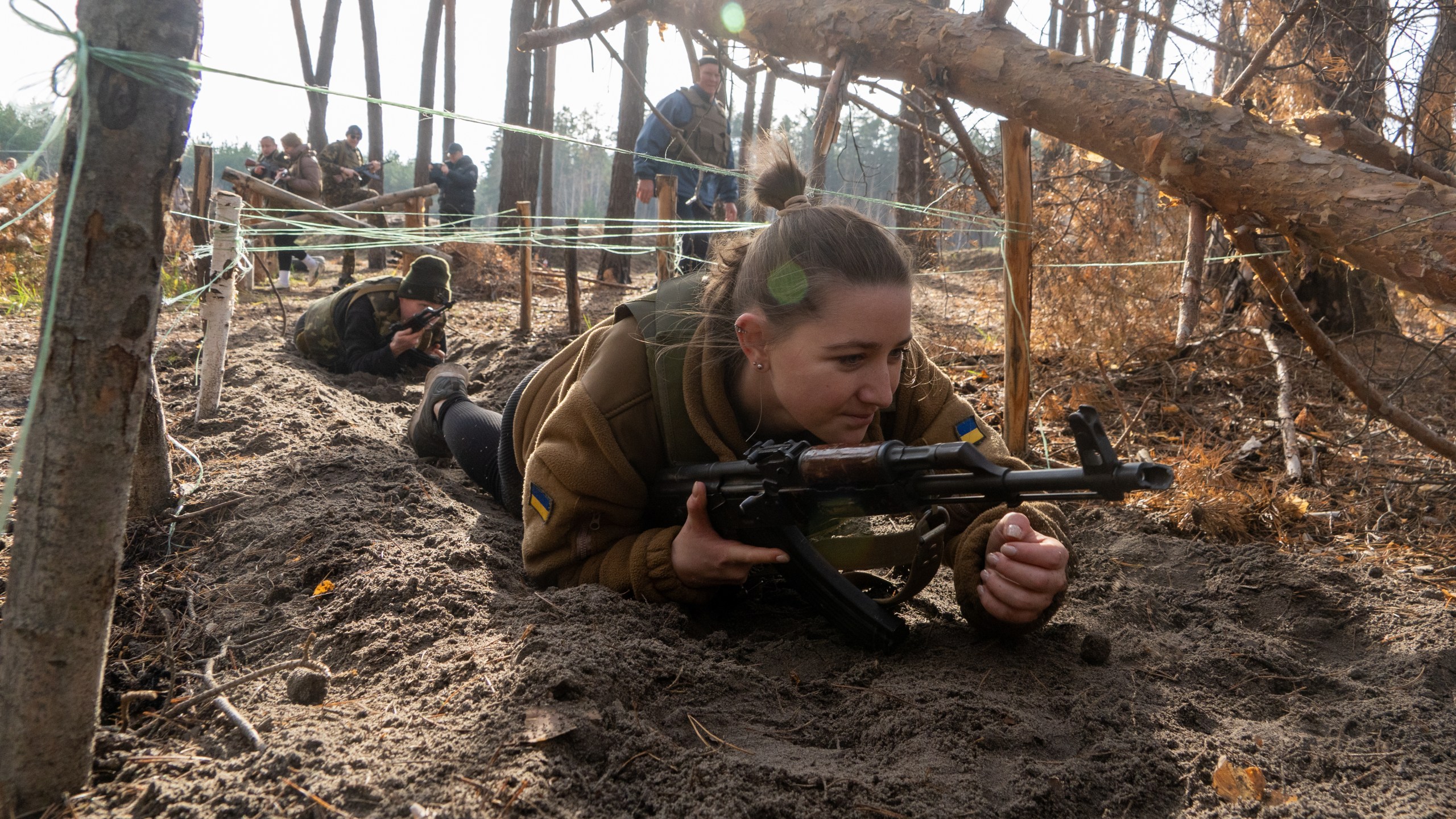 Civilians practice military skills on a training ground in Kharkiv region, Ukraine, Saturday, Nov. 15, 2025. (AP Photo/Andrii Marienko)