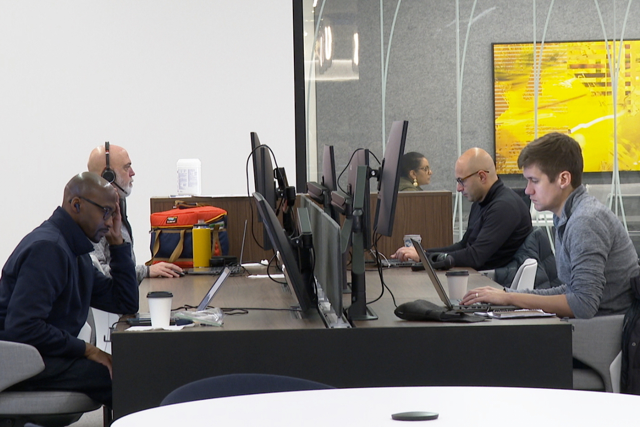 In this image taken from video, employees work in Ford Motor Co.'s new headquarters building, Monday, Nov. 10, 2025, in Dearborn, Mich. (AP Photo/Mike Householder)