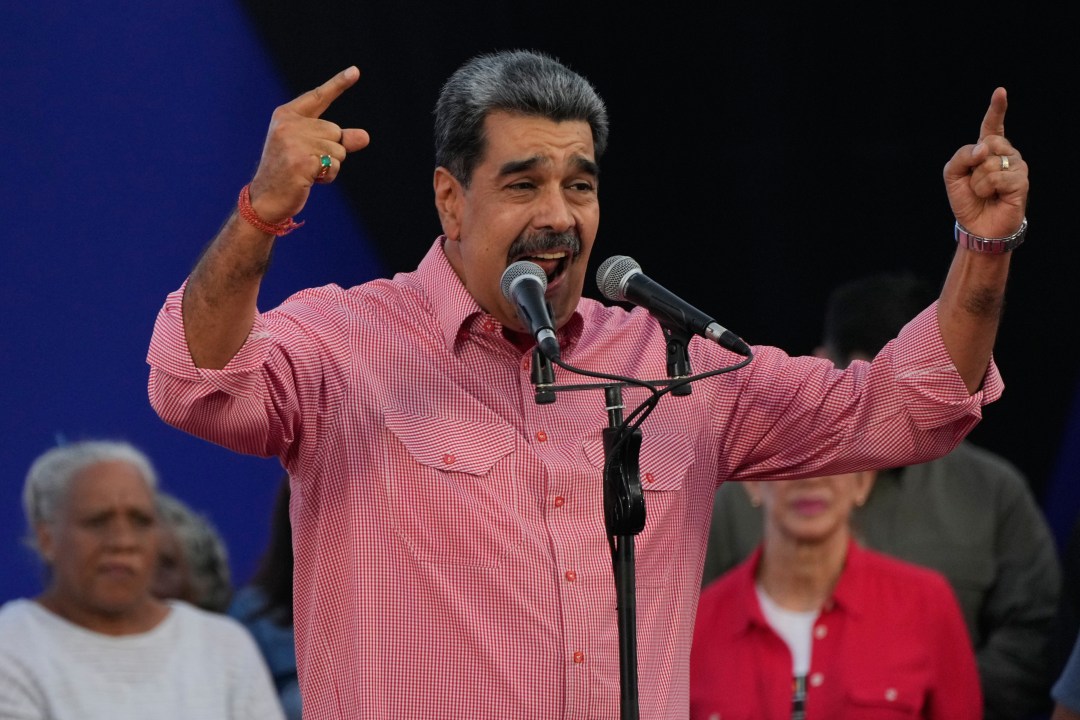 Venezuelan President Nicolas Maduro addresses civilians taking an oath to join a state-organized defense network in the Petare neighborhood of Caracas, Venezuela, Saturday, Nov. 15, 2025. (AP Photo/Ariana Cubillos)
