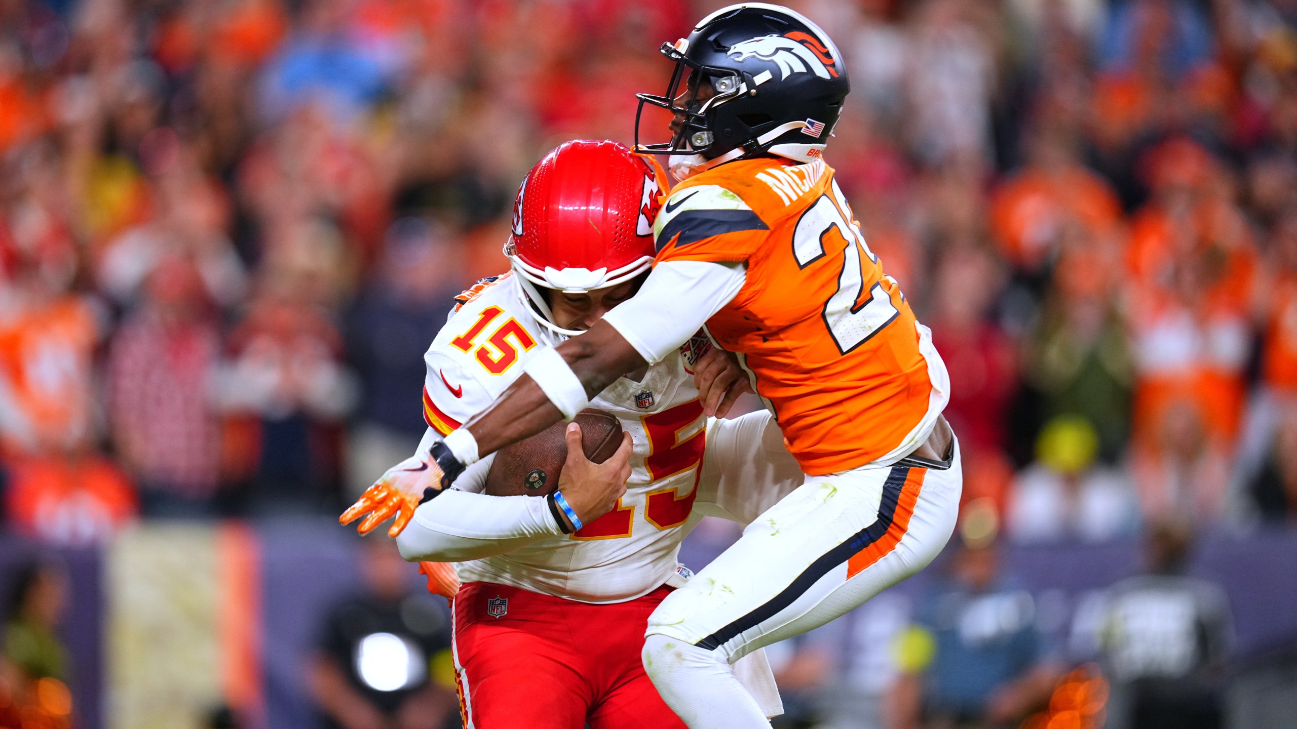 Denver Broncos cornerback Ja'Quan McMillian, right, sacks Kansas City Chiefs quarterback Patrick Mahomes (15) during the second half an NFL football game Sunday, Nov. 16, 2025, in Denver. (AP Photo/Jack Dempsey)