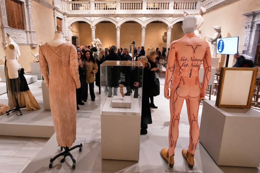A spandex bodysuit by Belgian designer Walter Van Beirendonck from a 2009 collection, right, is displayed during the announcement, at the Metropolitan Museum of Art, in New York, Monday, Nov. 17, 2025, about the next spring fashion exhibit "Costume Art," which is set to launch at the Met Gala in 2026. (AP Photo/Richard Drew)
