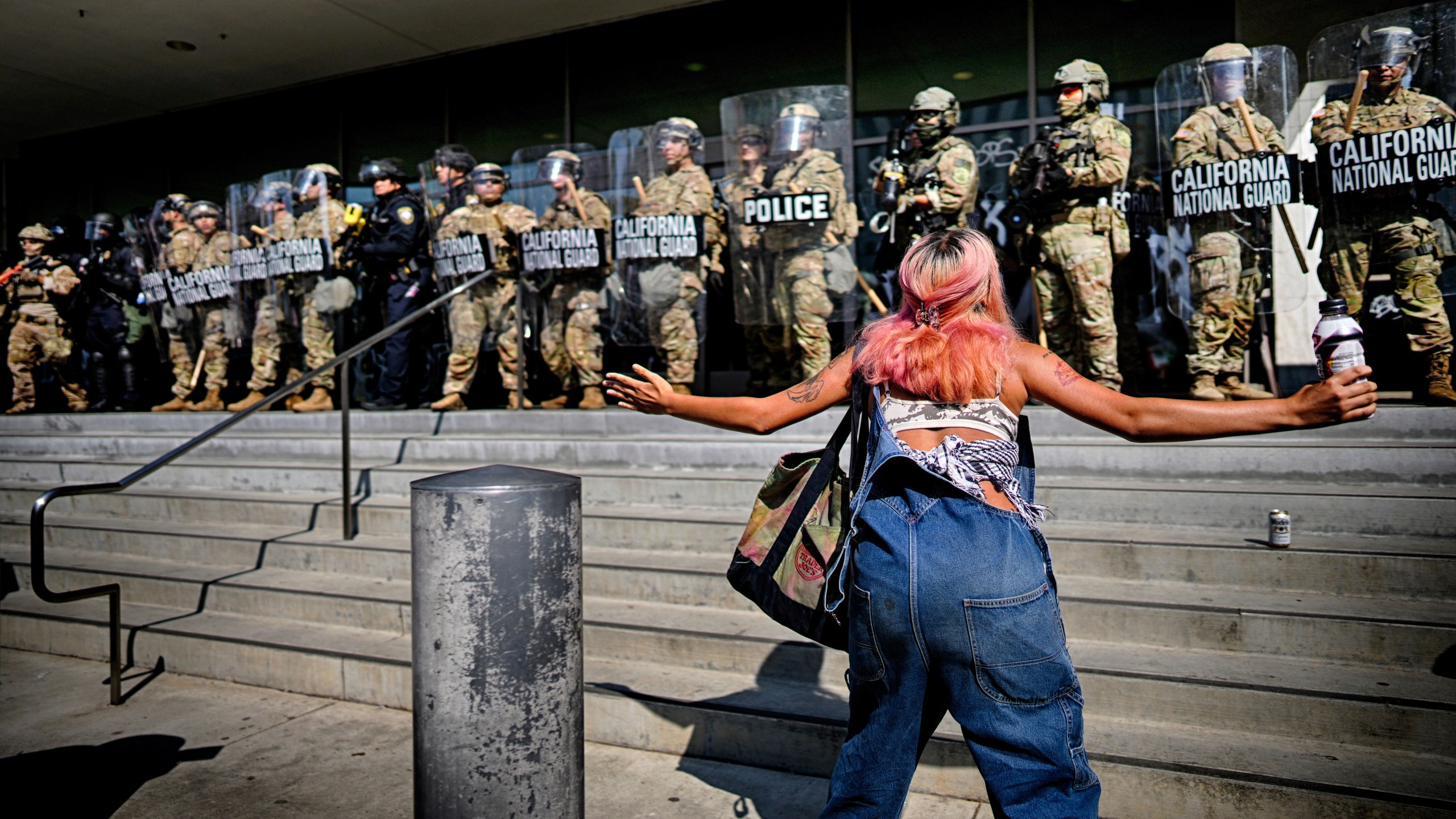 FILE - A protester taunts a line of California National Guard protecting a federal building in downtown Los Angeles on June 9, 2025. (AP Photo/Eric Thayer, File)