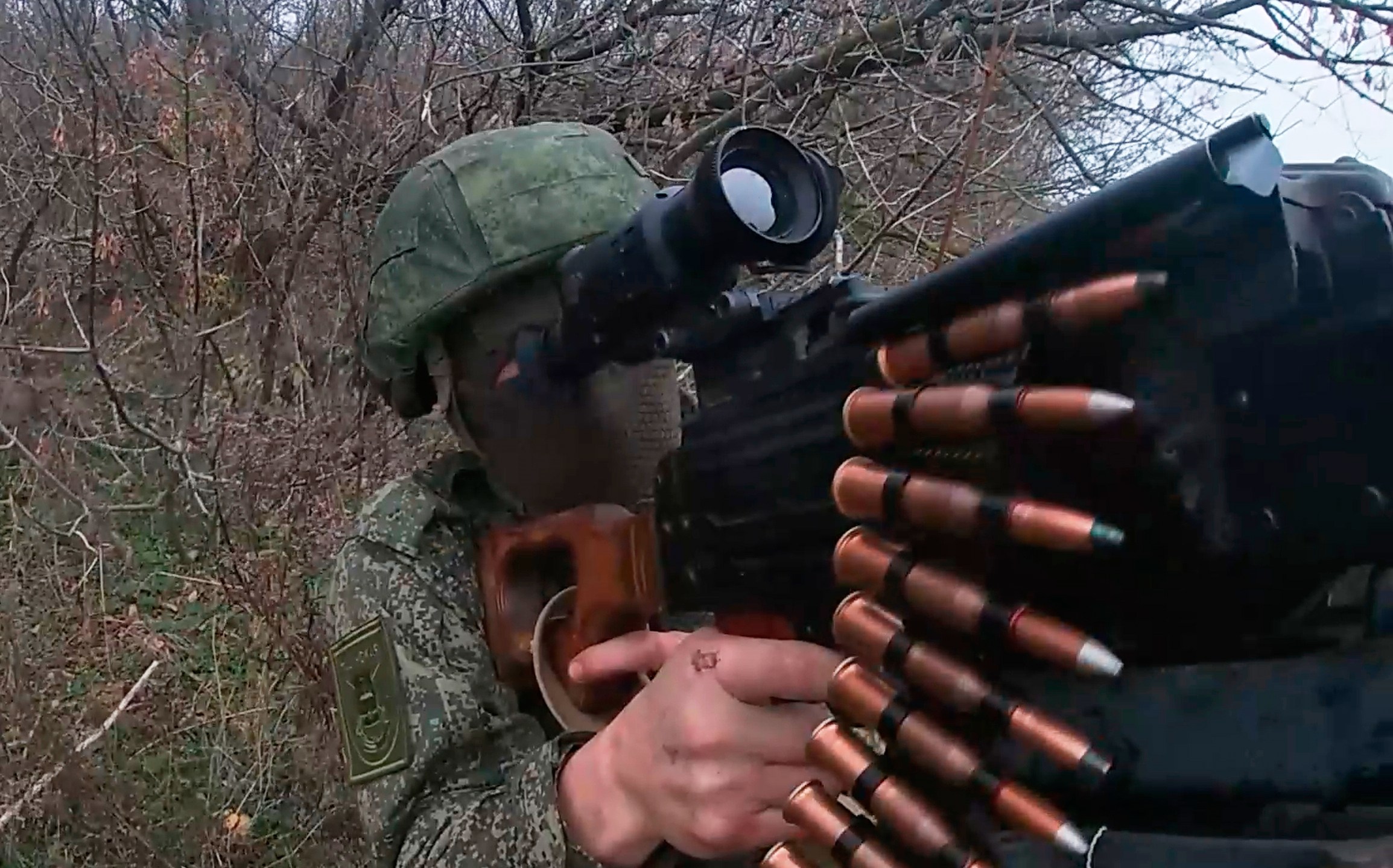 In this photo taken from a video provided by Russian Defense Ministry press service on Tuesday, Nov. 18, 2025, Russian serviceman fires in an undisclosed location in Ukraine. (Russian Defense Ministry Press Service via AP)