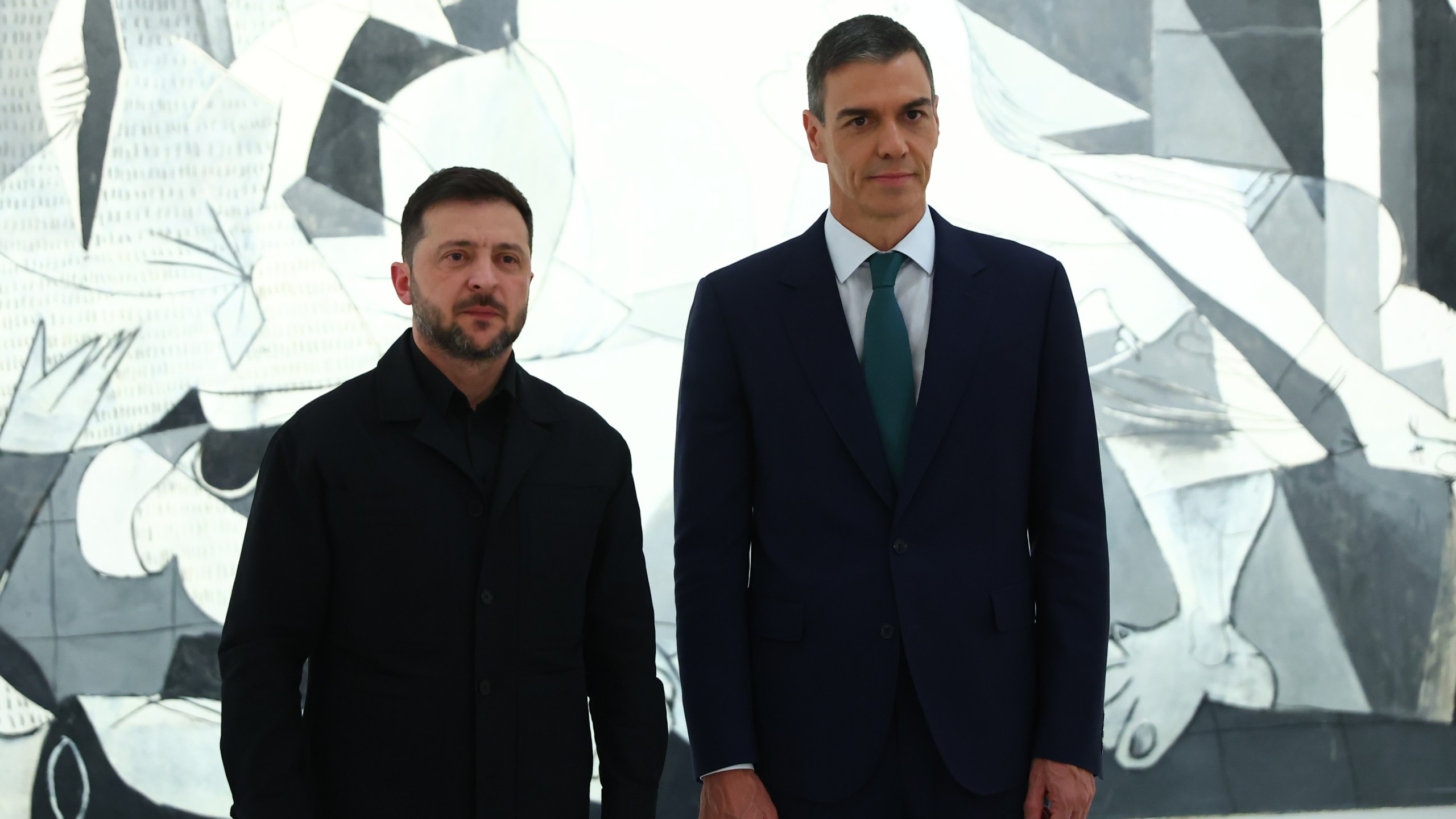 In this photo provided by the Spanish government, Ukrainian President Volodymyr Zelenskyy poses with Spain's Prime Minister Pedro Sánchez in front of Pablo Picasso's "Guernica" in Madrid Tuesday, Nov. 18, 2025. (Spanish government via AP)