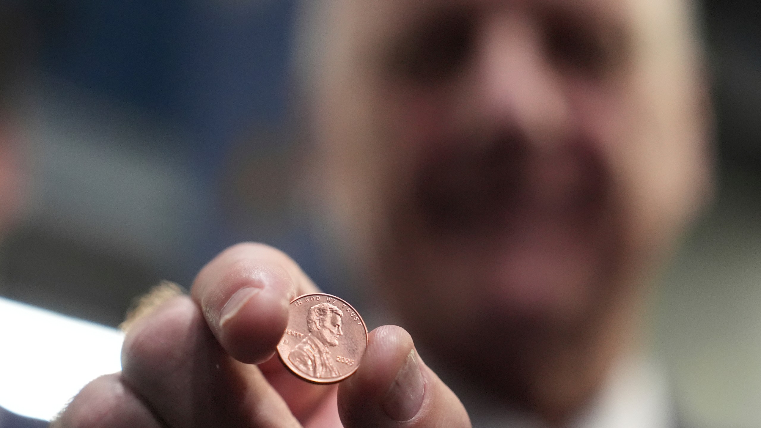 U.S. Treasurer Brandon Beach holds one of the last pennies pressed at the U.S. Mint in Philadelphia, Wednesday, Nov. 12, 2025. (AP Photo/Matt Slocum)