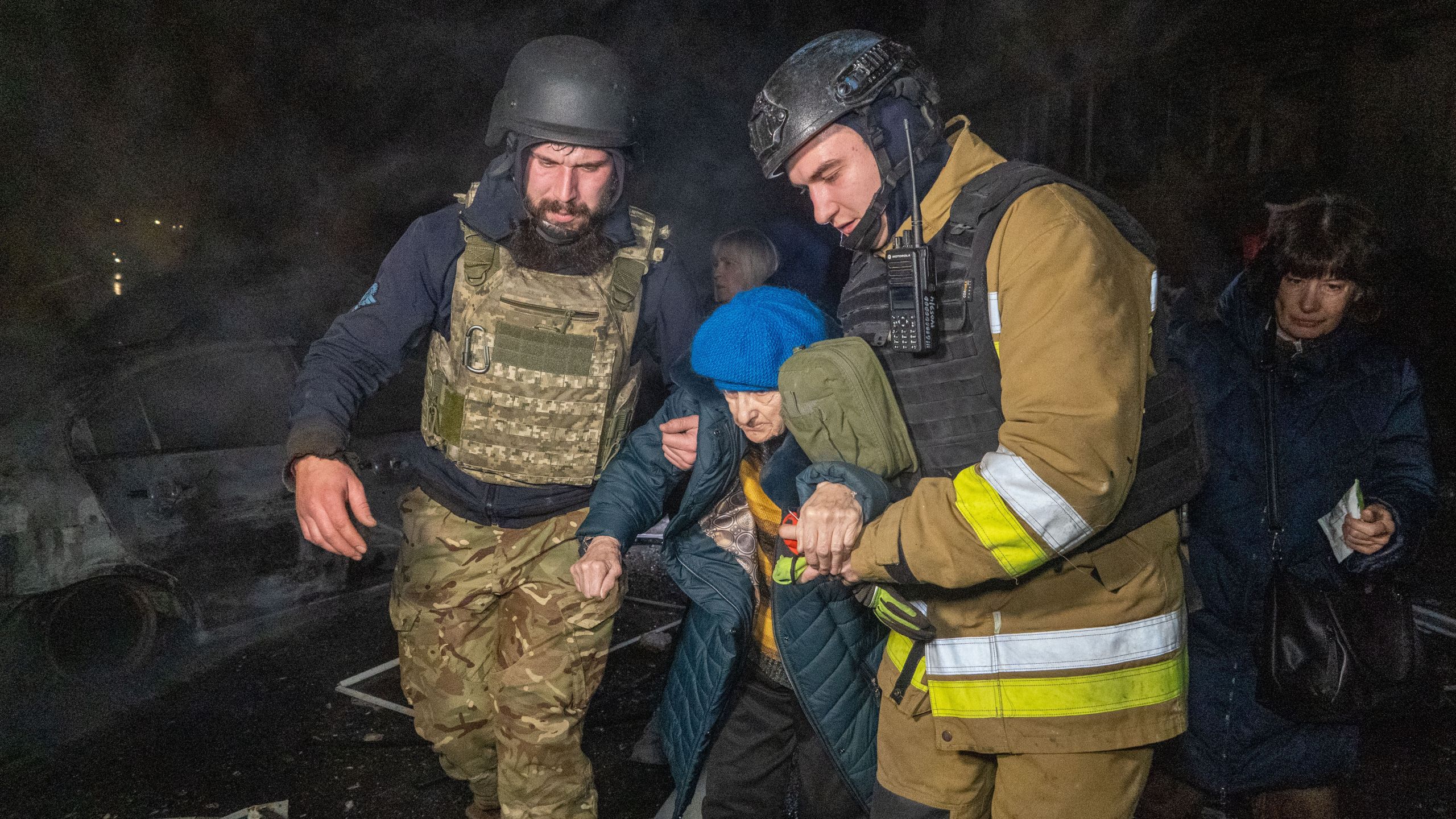 Rescuers evacuate an elderly woman after a residential building was hit following Russia's missile attack in Kharkiv, Ukraine Wednesday, Nov. 19, 2025. (AP Photo/Andrii Marienko)