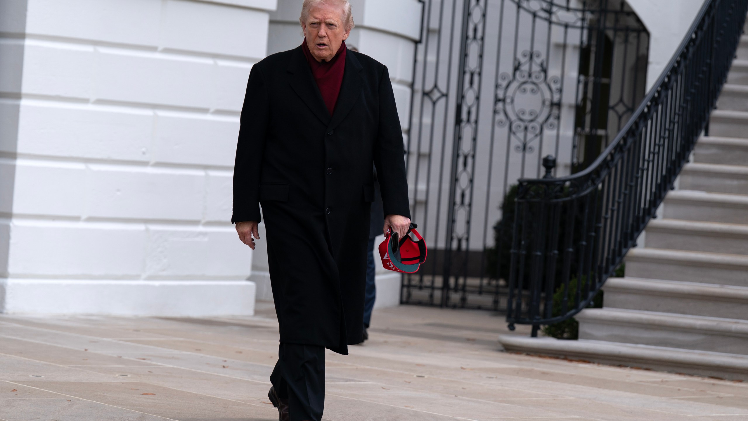President Donald Trump walks towards reporters from the South Lawn of the White House, Saturday, Nov. 22, 2025, in Washington, en route to Joint Base Andrews. (AP Photo/Jose Luis Magana)