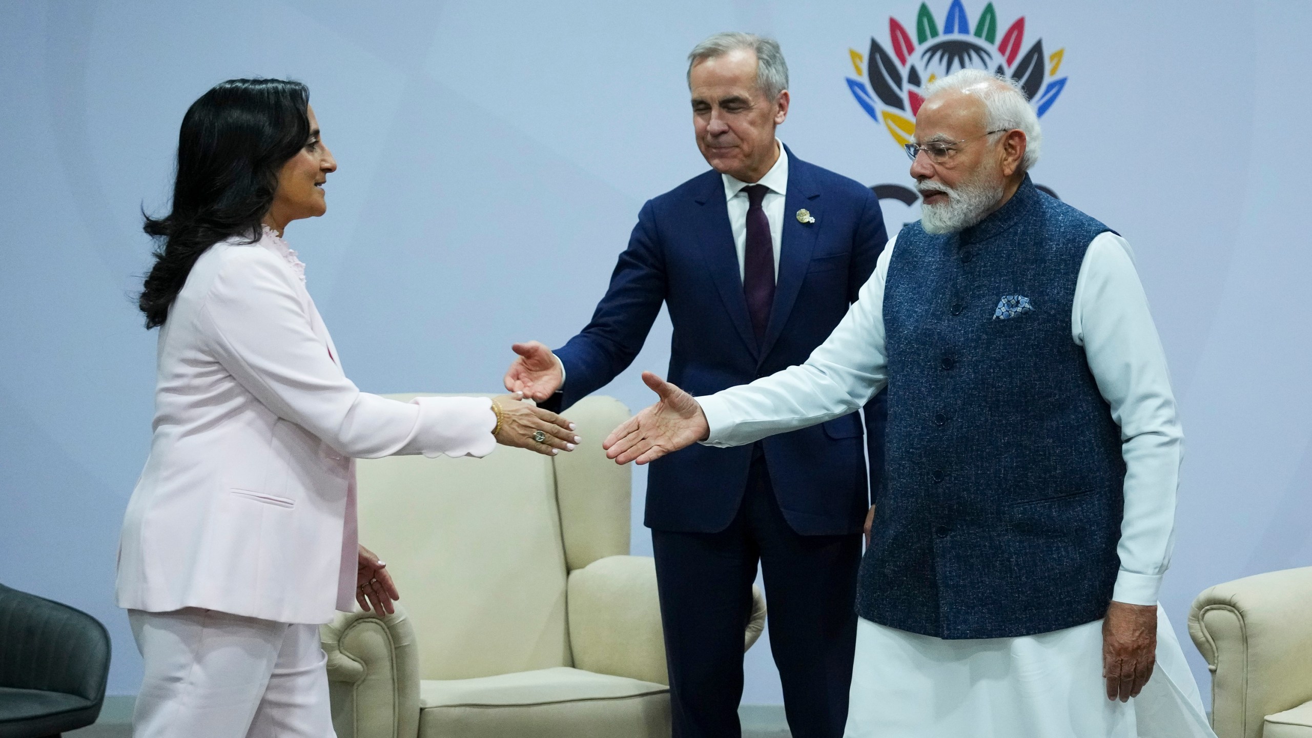 Canada's Prime Minister Mark Carney, middle, introduces Minister of Foreign Affairs Anita Anand, left, during a bilateral meeting with Indian Prime Minister Narendra Modi during the G20 Summit, in Johannesburg, Sunday, Nov. 23, 2025. (Sean Kilpatrick/The Canadian Press via AP)