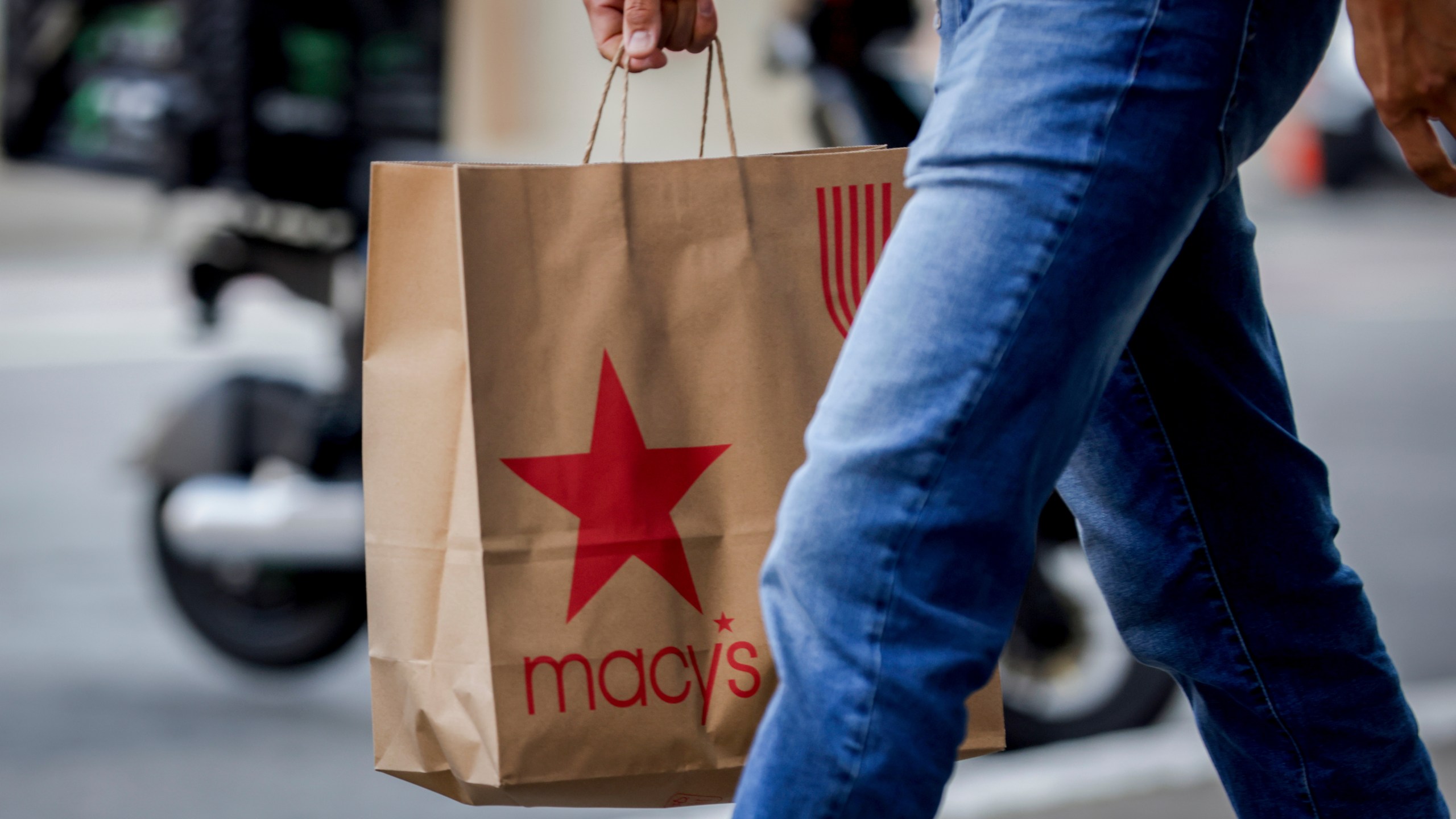 A shopper carries a Macy's bag through Union Square as retailers prepare for Black Friday in San Francisco on Tuesday, Nov. 25, 2025. (Brontë Wittpenn/San Francisco Chronicle via AP)