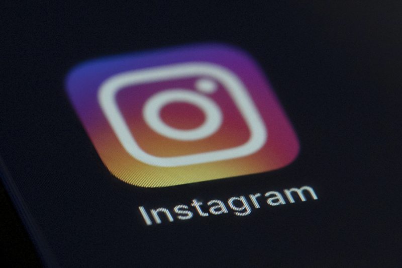 The Instagram logo on a black screen on a smartphone